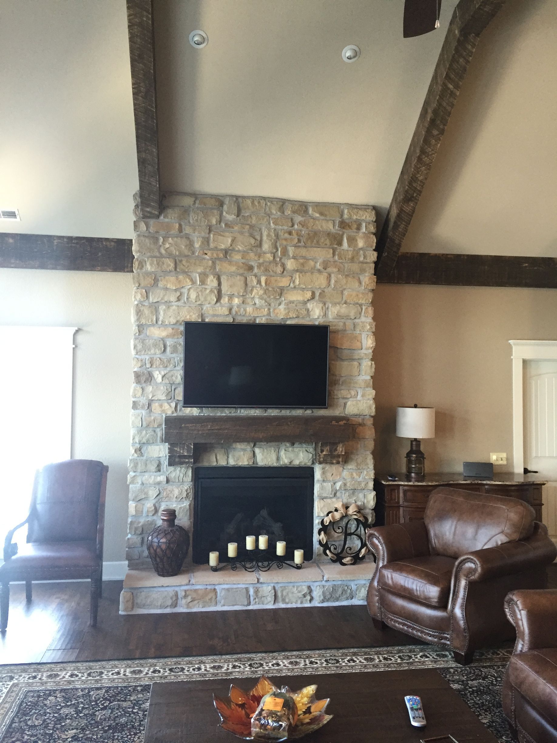 A living room with a fireplace and a flat screen tv