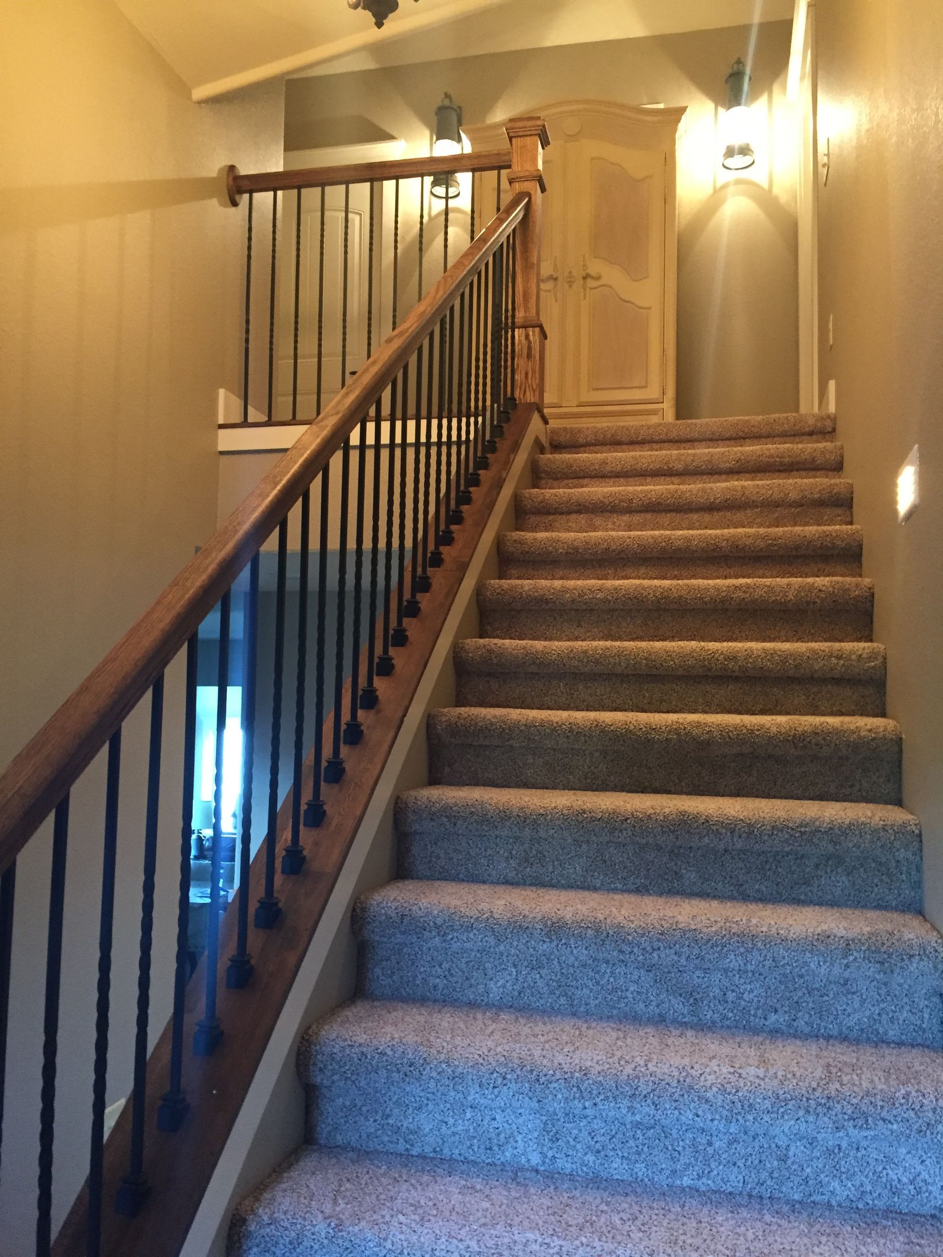 A staircase with carpeted steps and a wooden railing