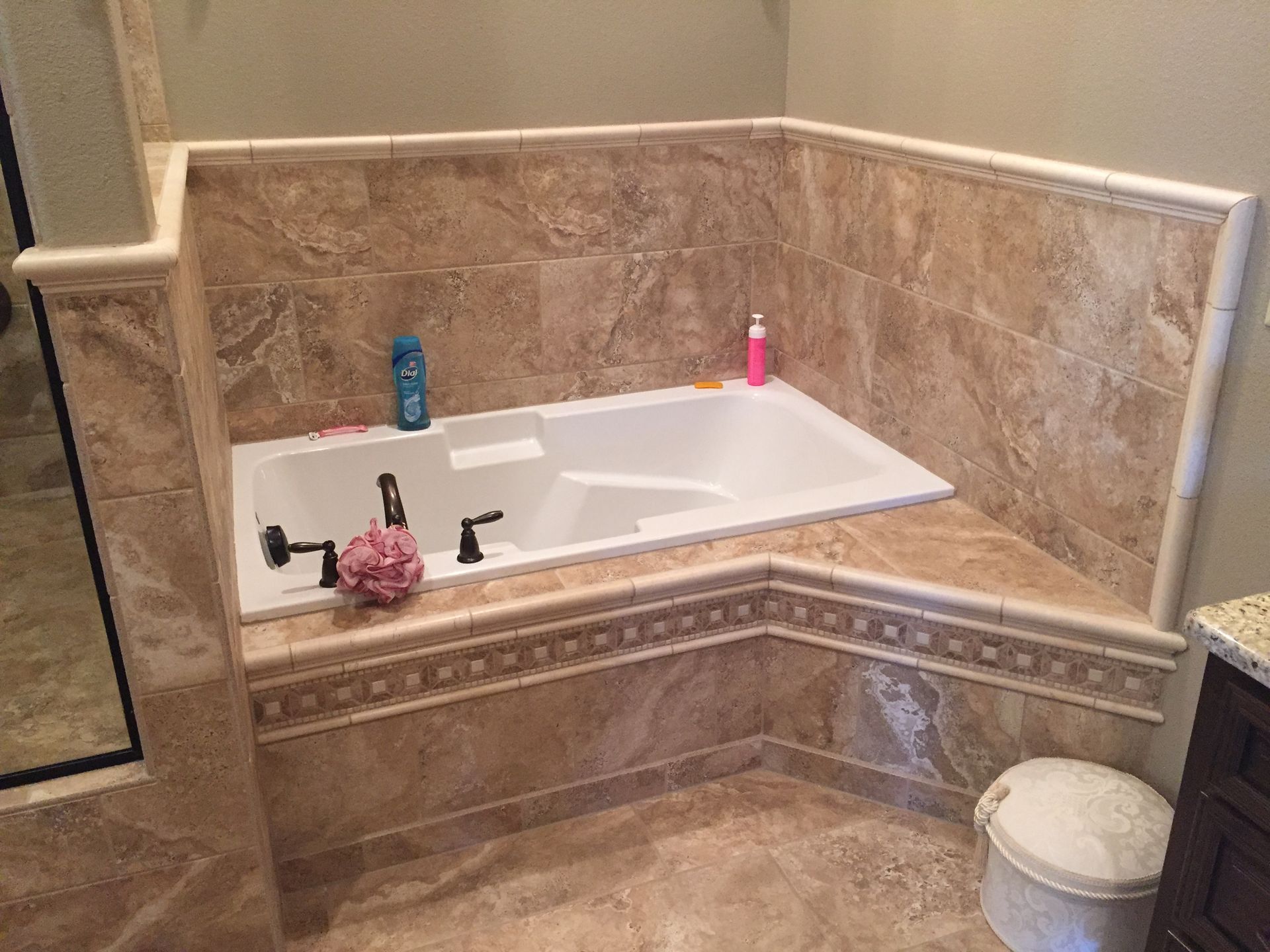 There is a bathtub in the corner of the bathroom.