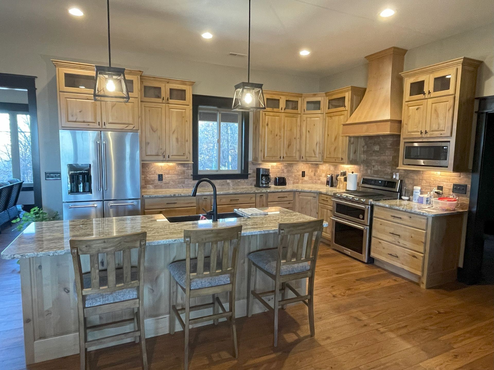 A kitchen with stainless steel appliances and wooden cabinets.