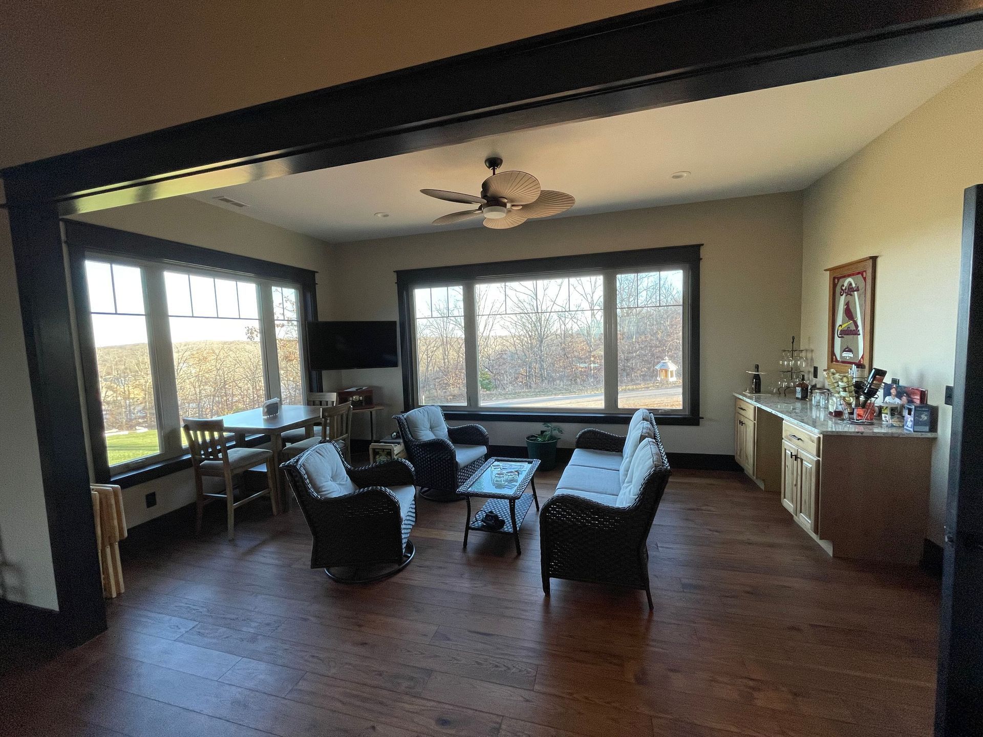 A living room with a lot of furniture and a ceiling fan