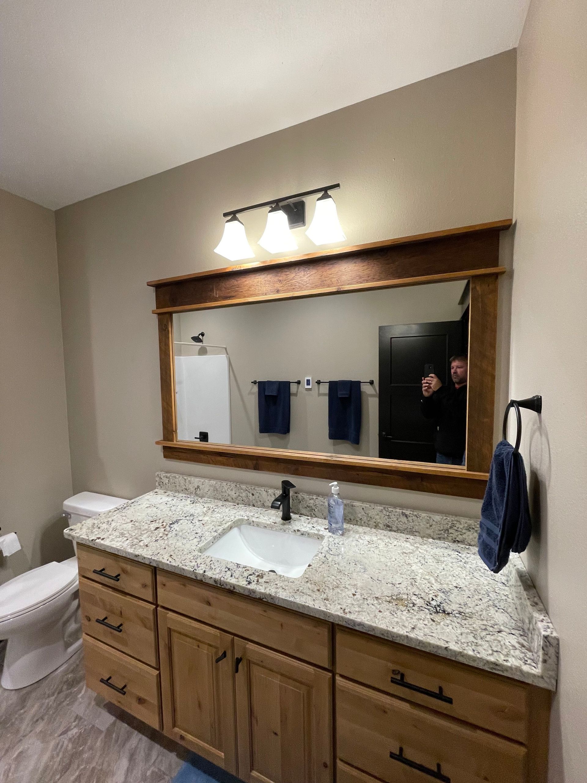 A bathroom with a sink , toilet , and mirror.