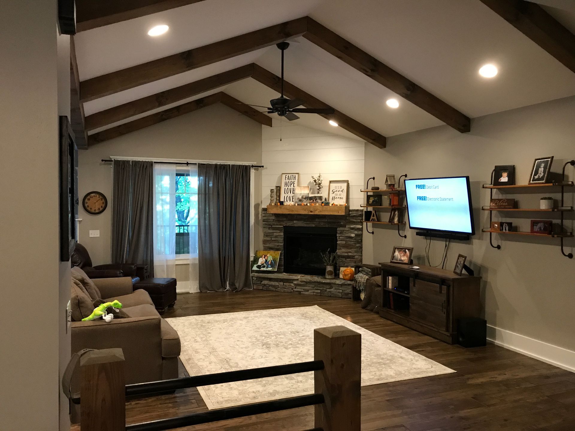 A living room with a fireplace and a flat screen tv.