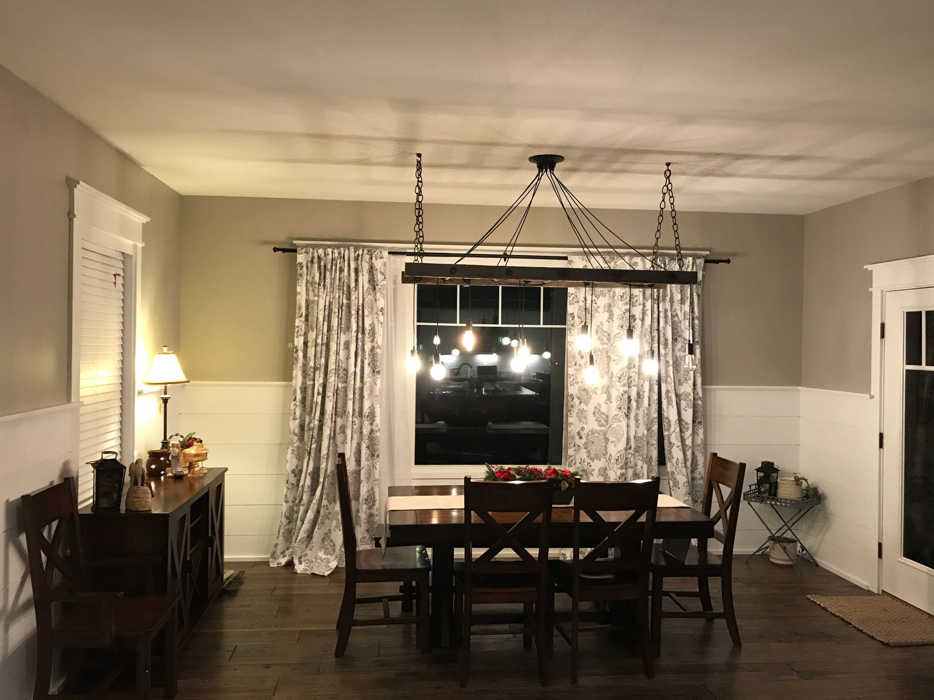 A dining room with a table and chairs and a chandelier