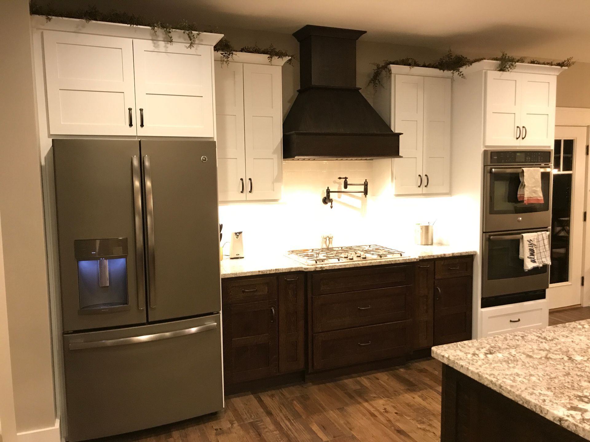A kitchen with stainless steel appliances and white cabinets