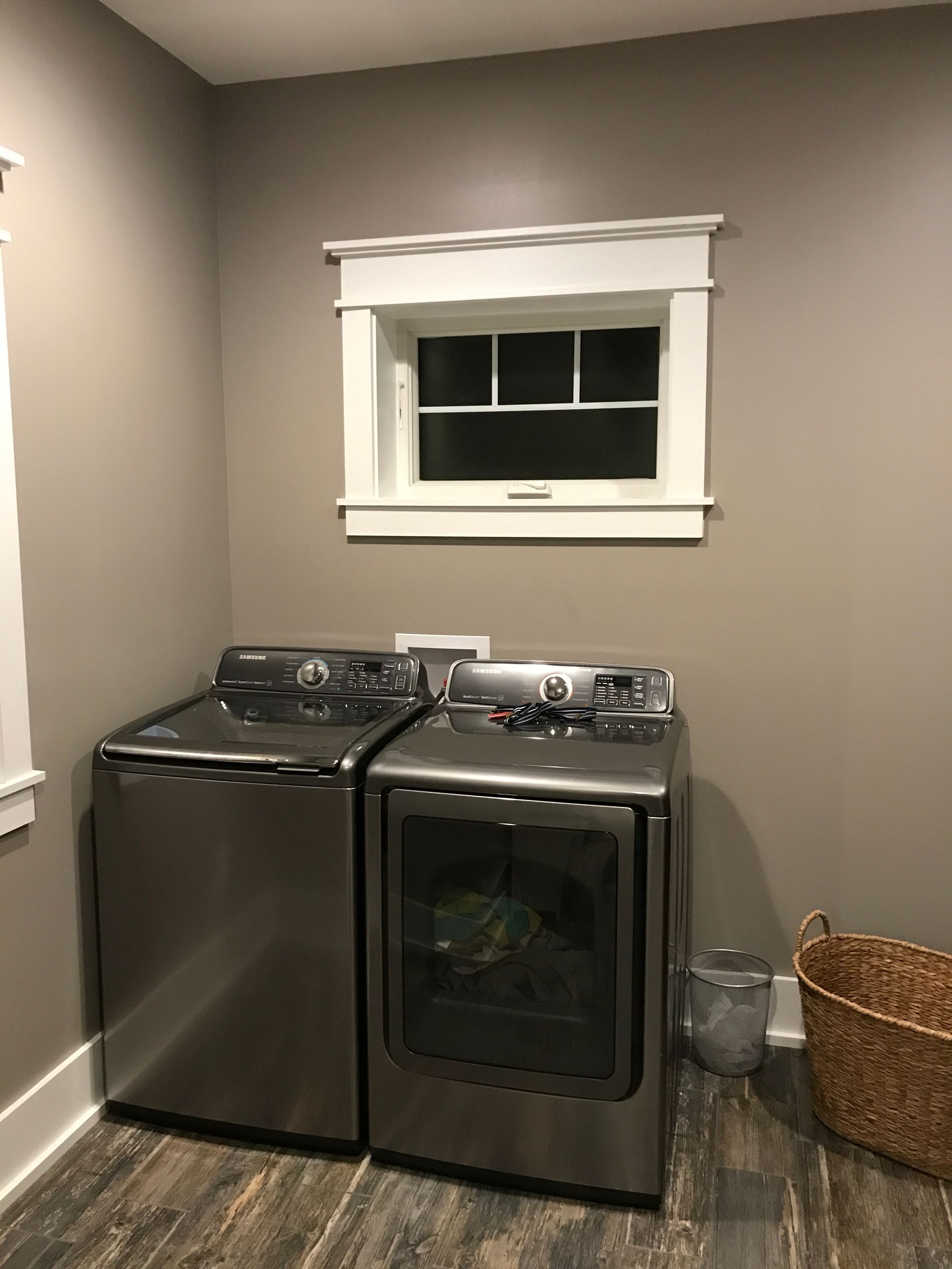 A laundry room with a washer and dryer and a window.