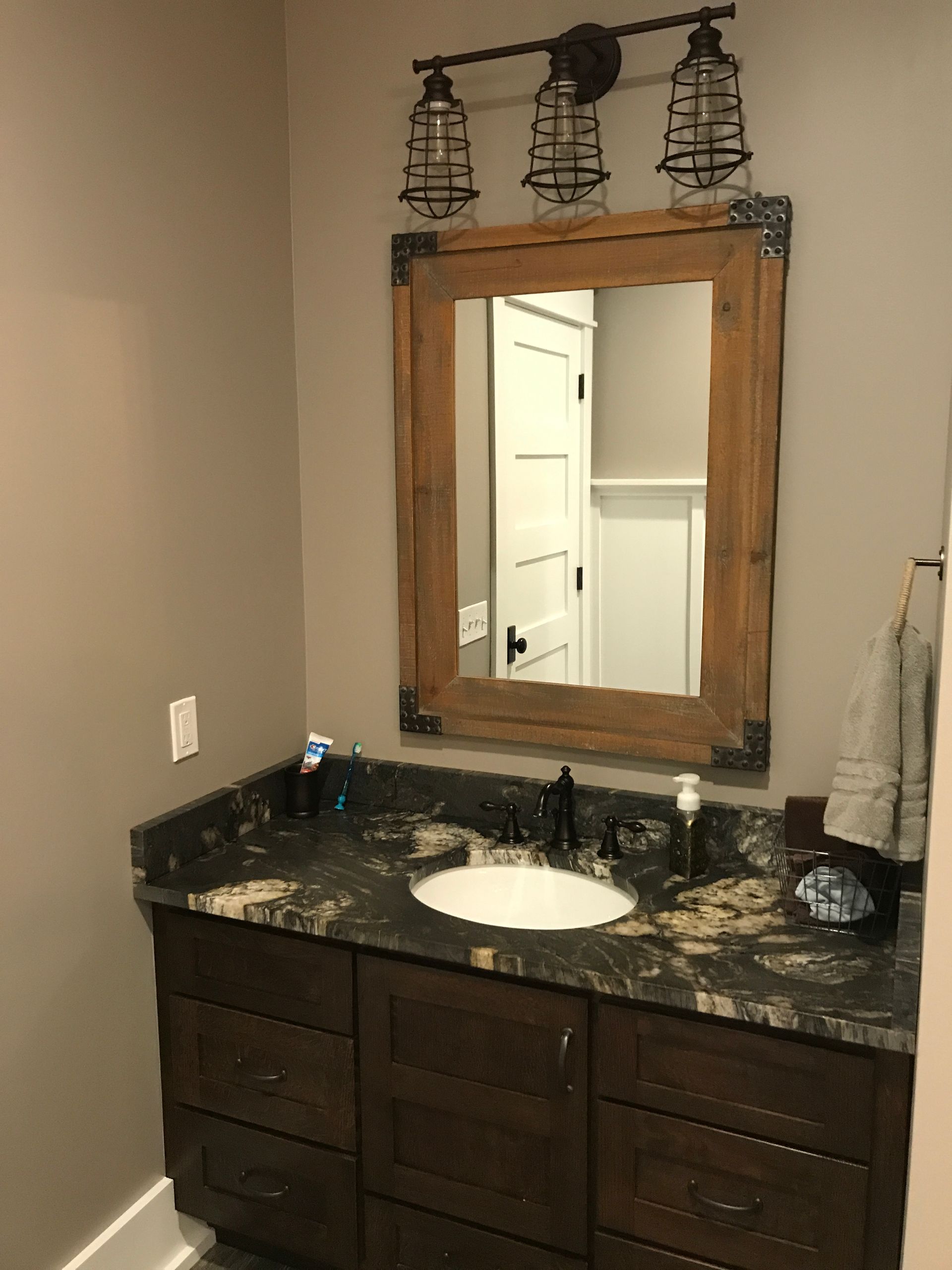 A bathroom with a sink and a mirror on the wall.