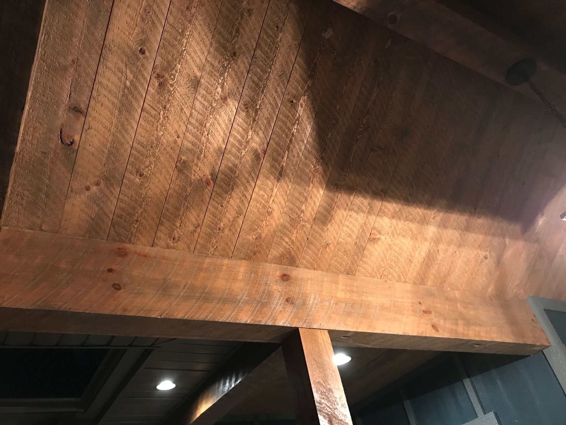 A close up of a wooden ceiling in a room.