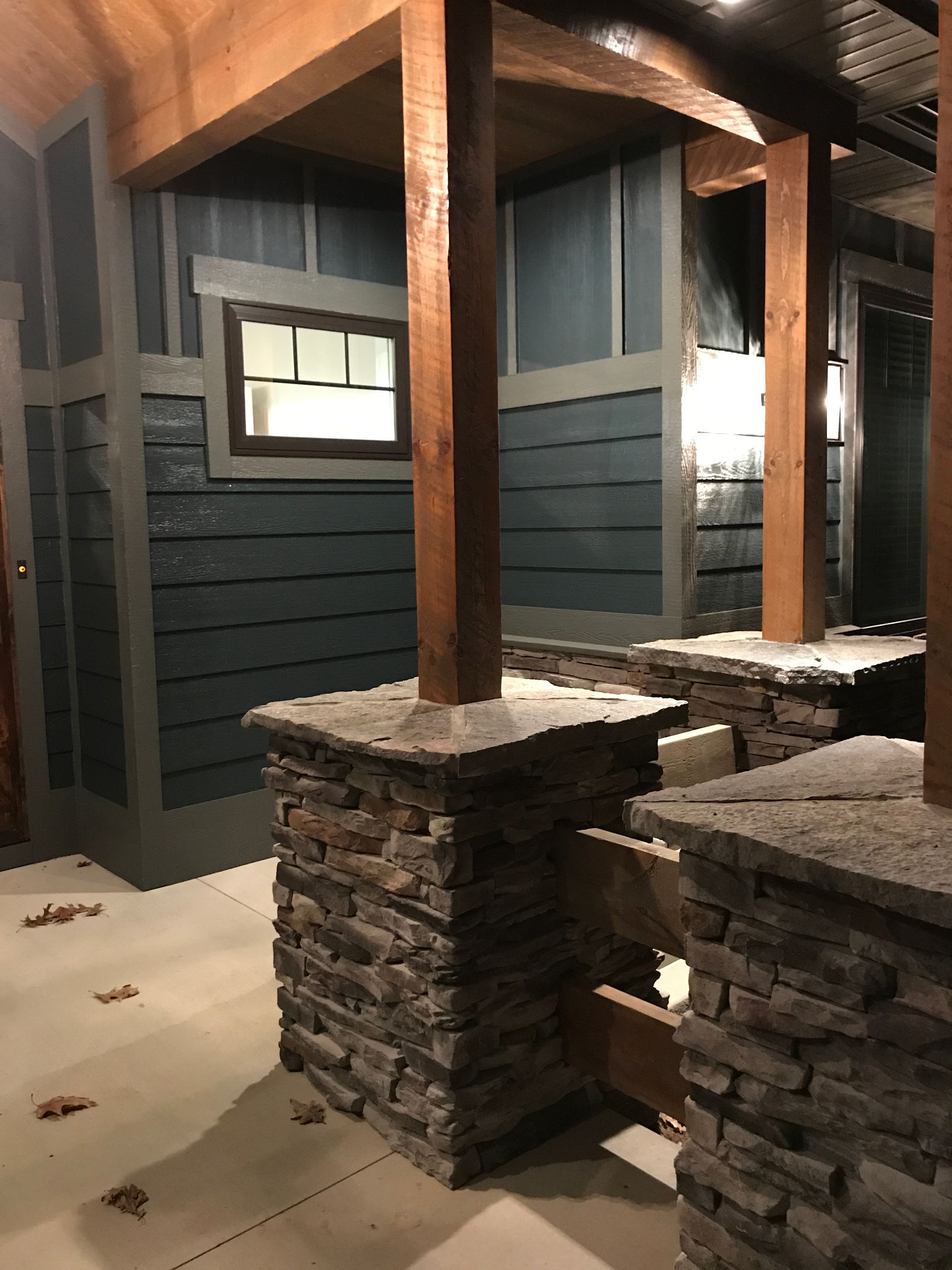 A room with a brick wall and wooden pillars