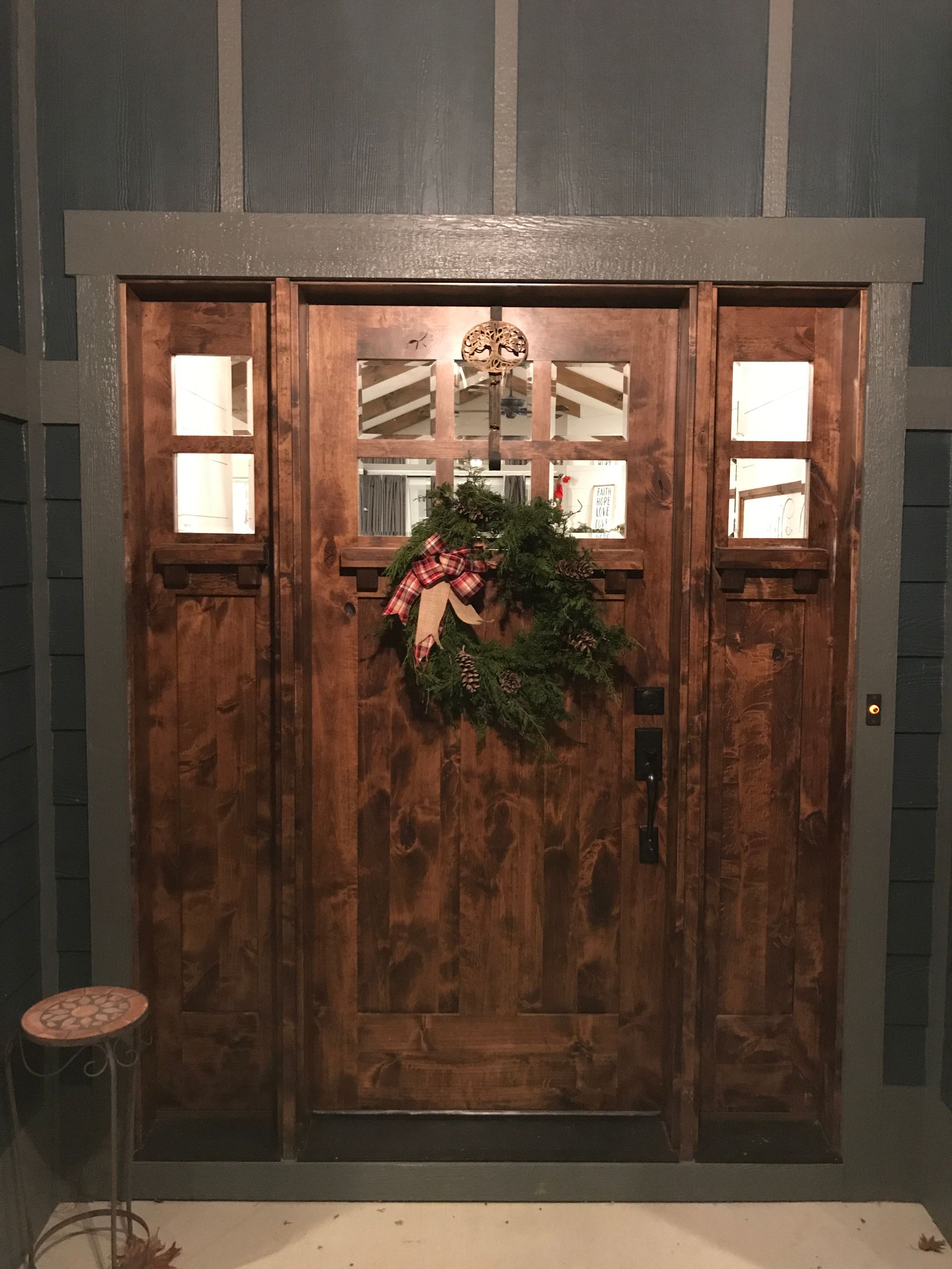 A wooden door with a wreath hanging on it.