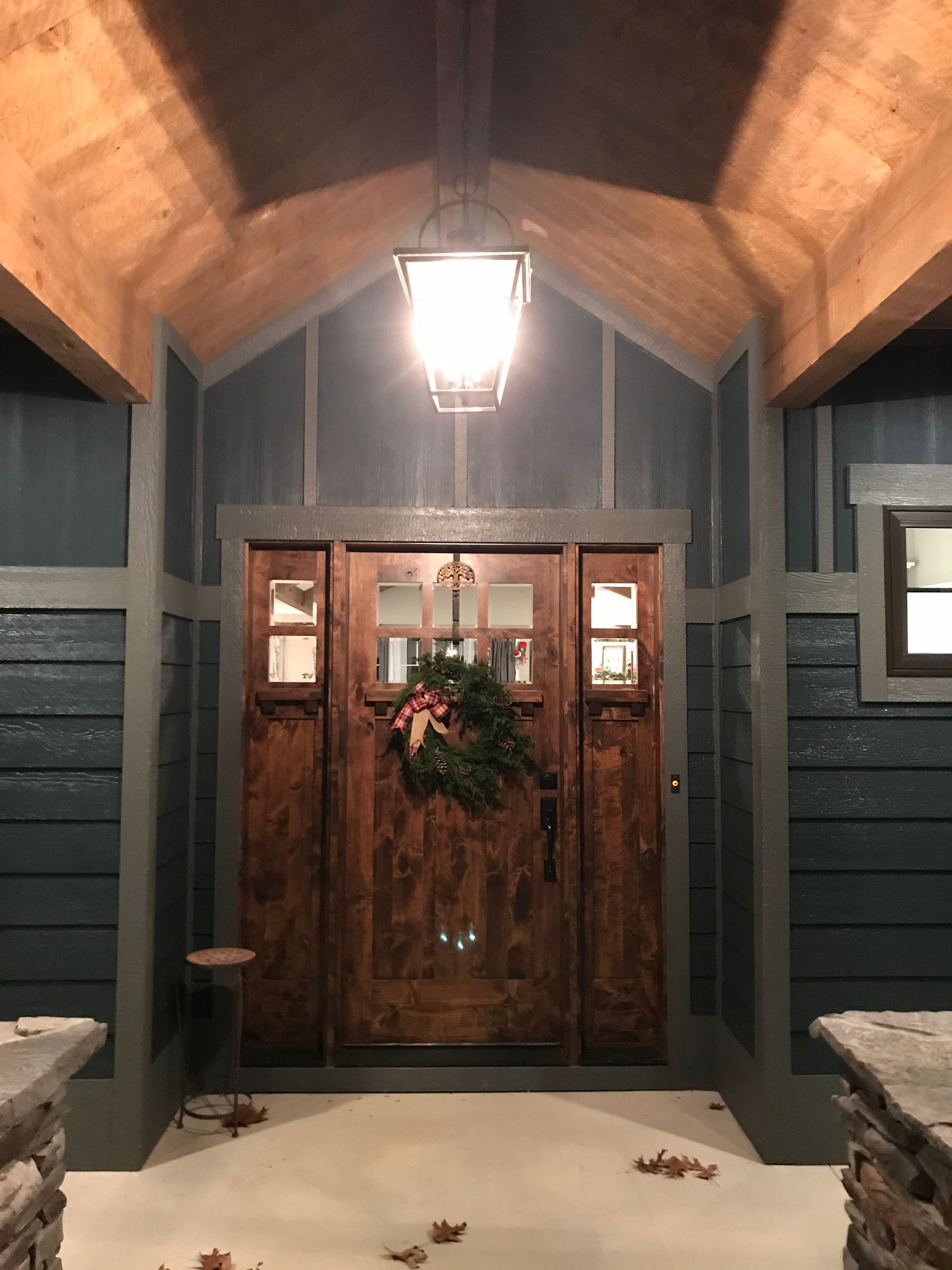 The front door of a house with a wreath on it