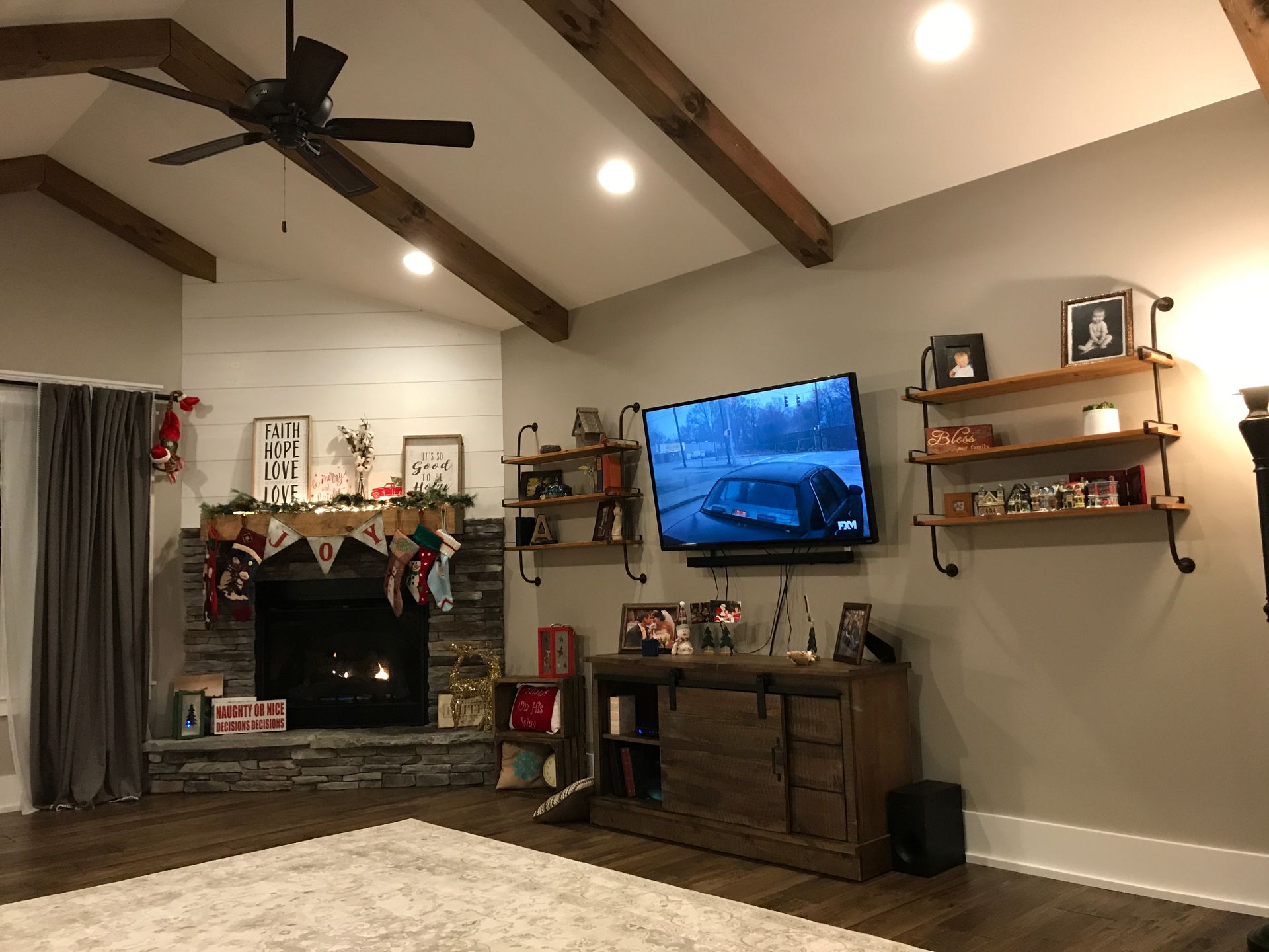 A living room with a fireplace and a flat screen tv.