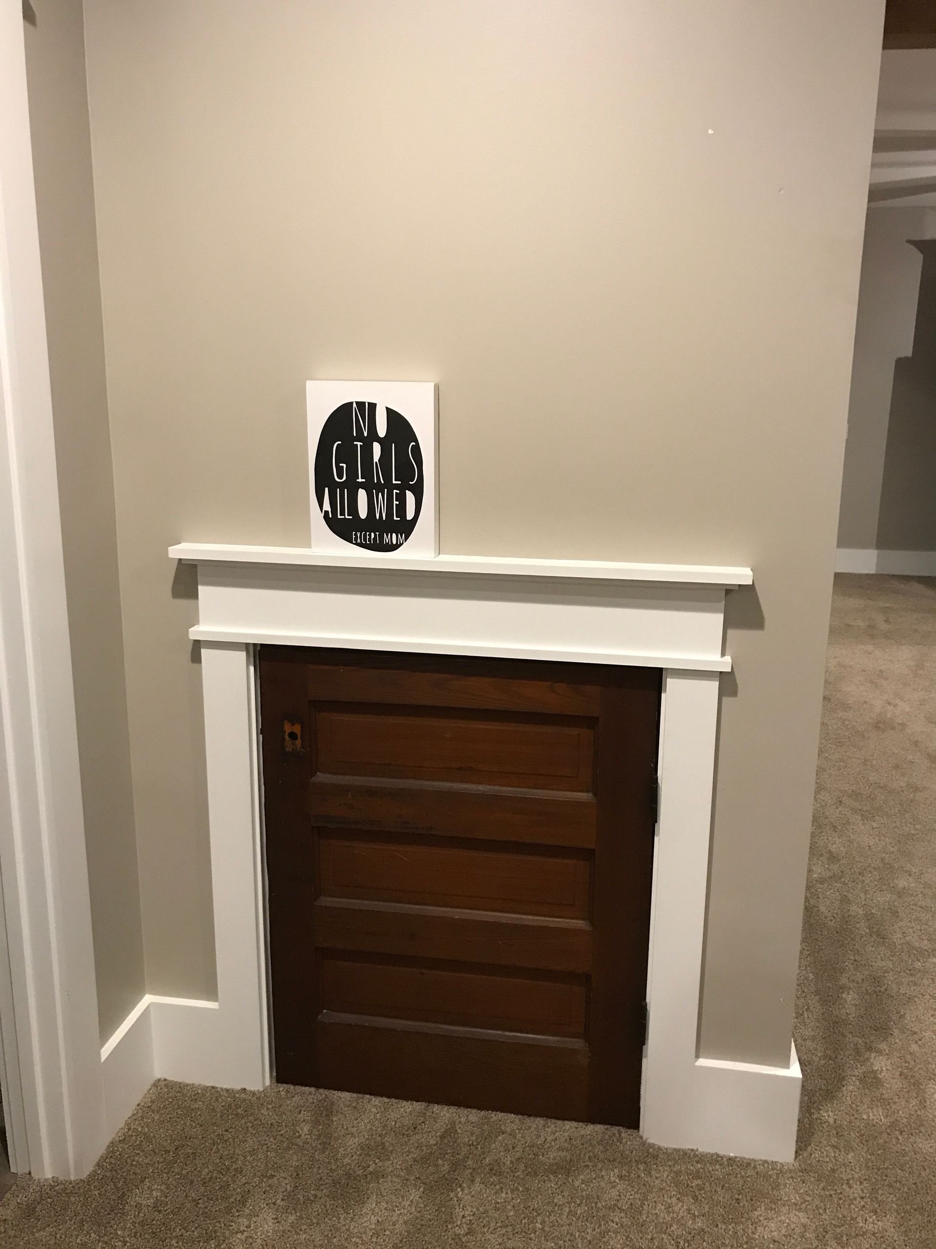 A door in a wall with a picture on top of it.