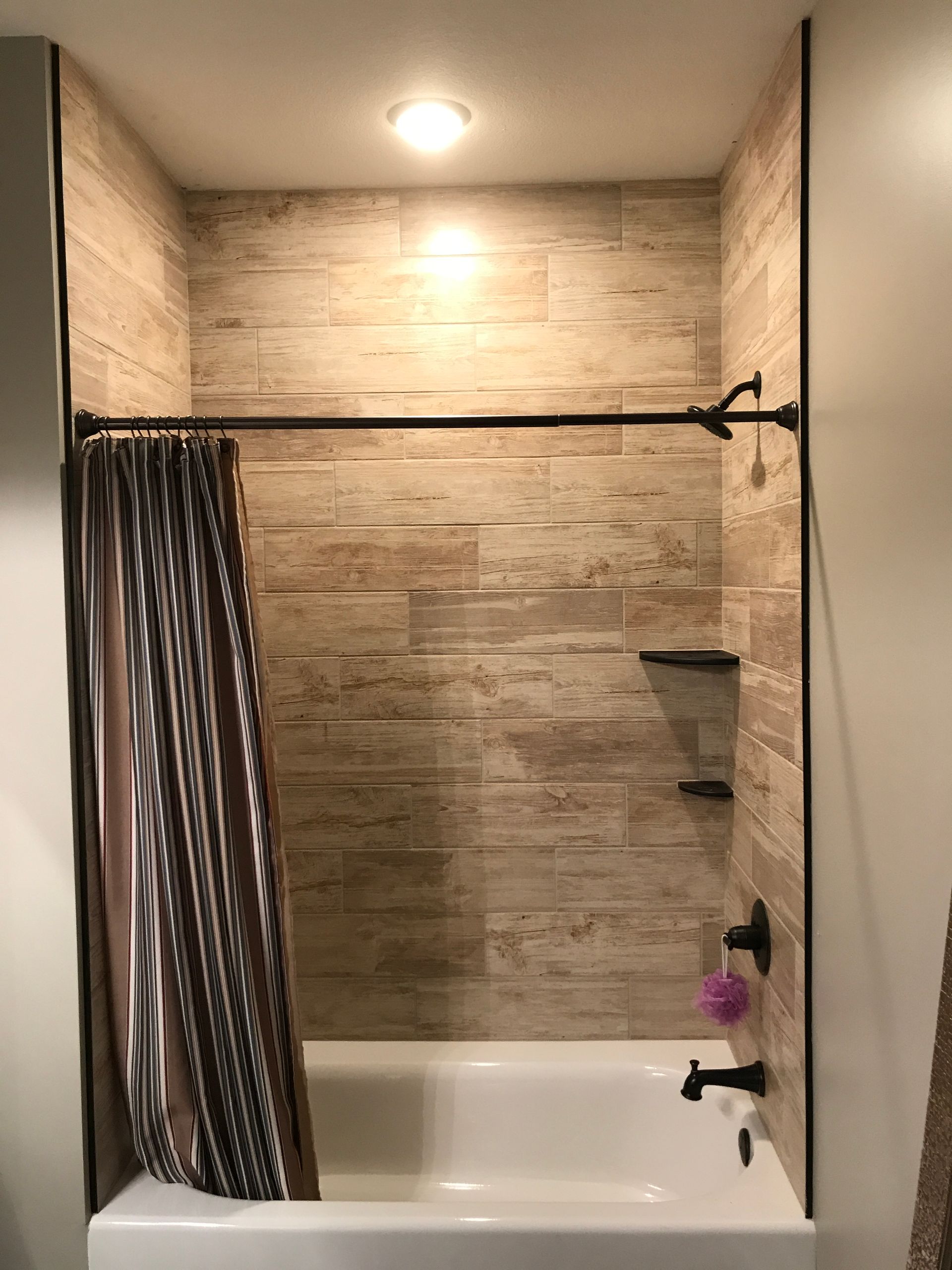 A bathroom with a bathtub and a shower curtain.