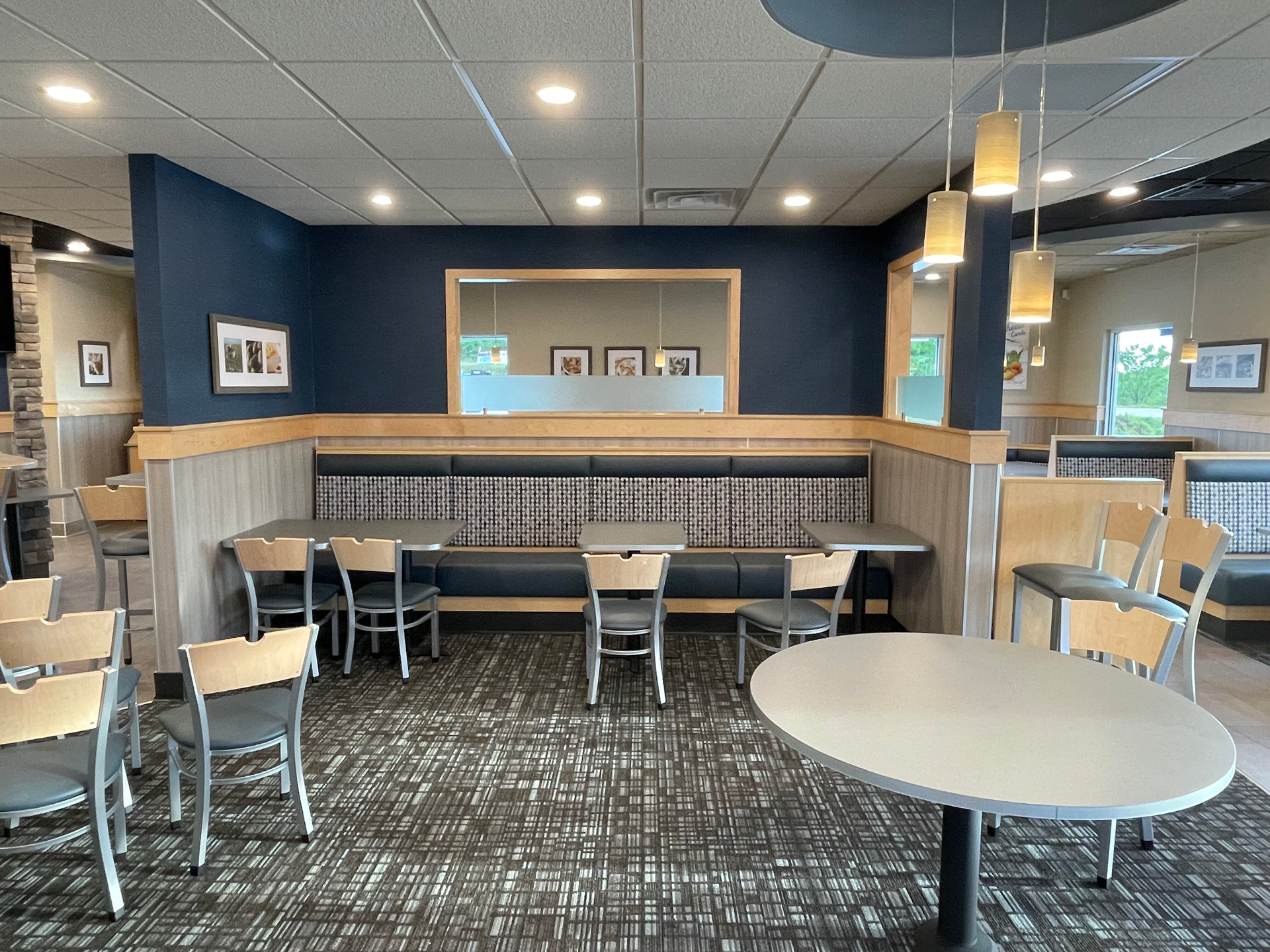 A dining room with tables and chairs in a restaurant.
