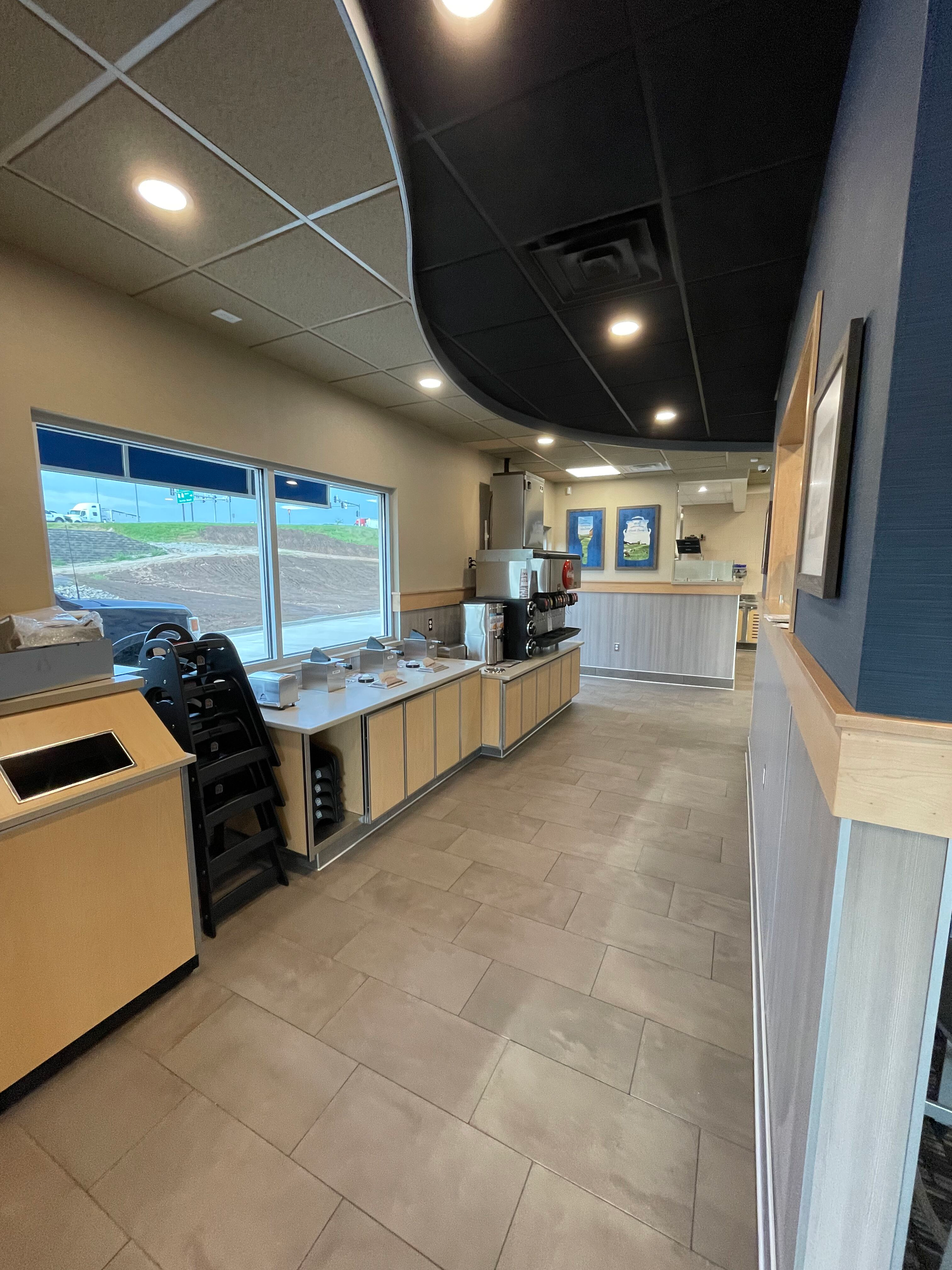 A long hallway leading to a counter in a restaurant