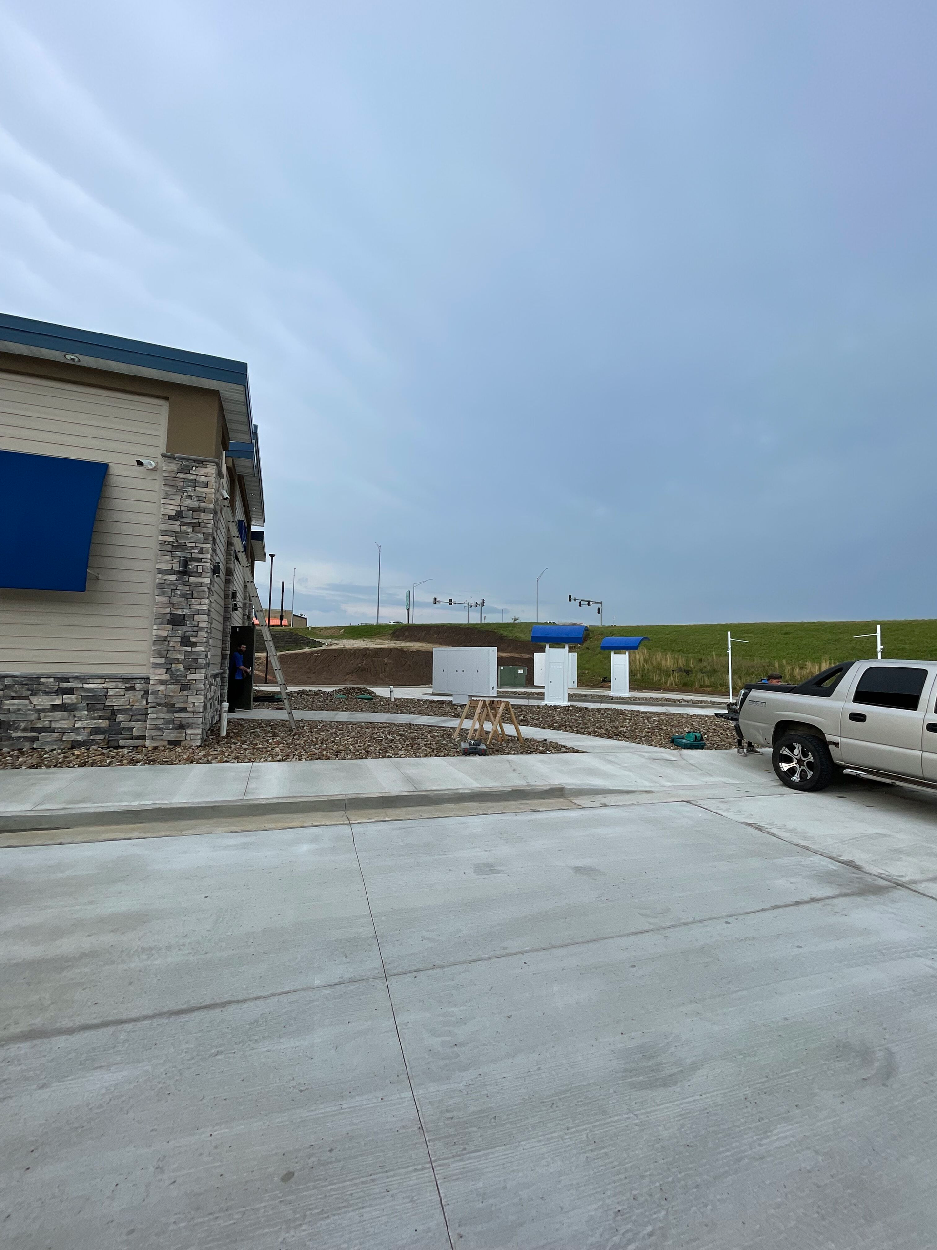 A white truck is parked in front of a building.