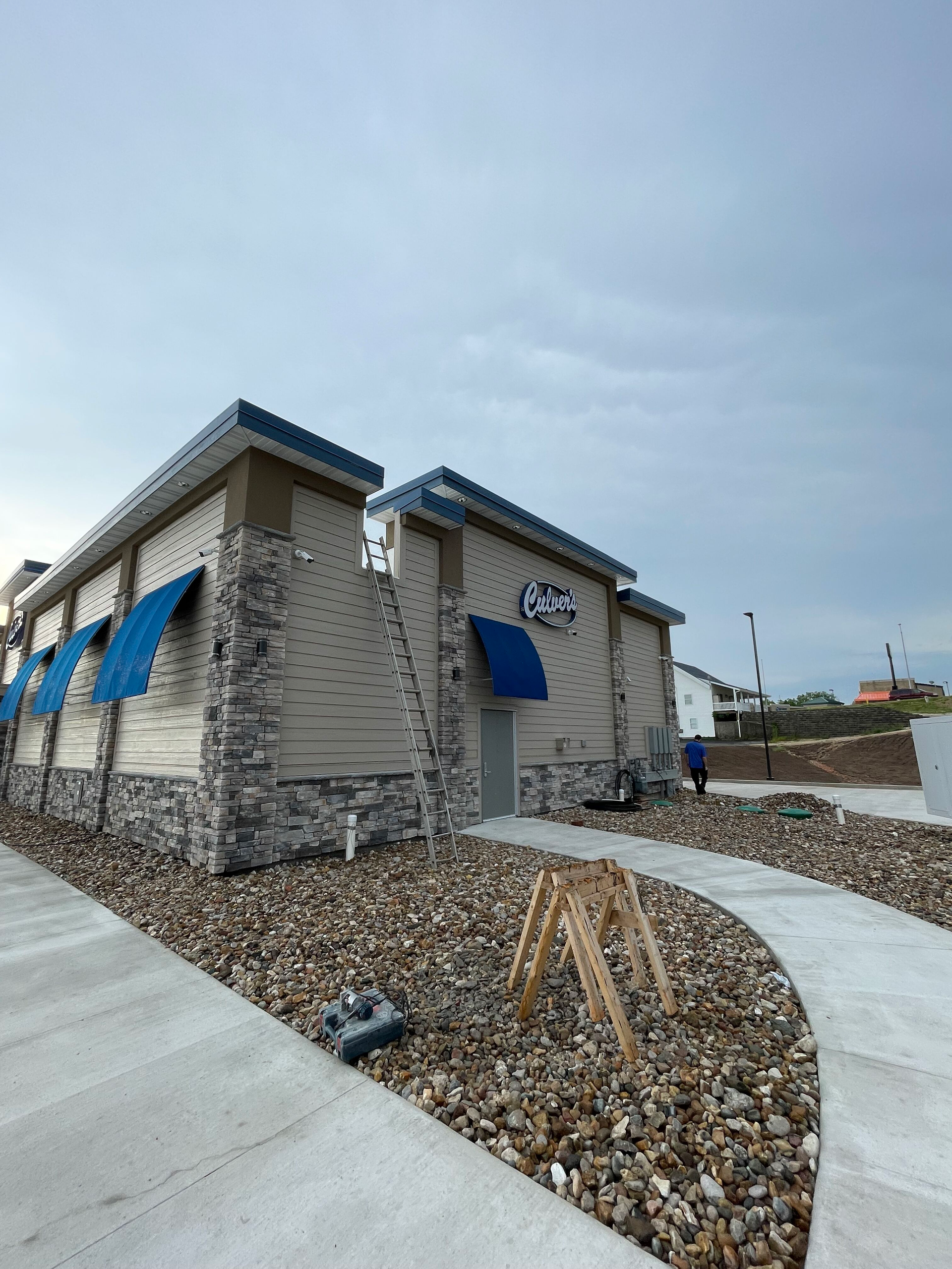 A building with a blue awning on the side of it