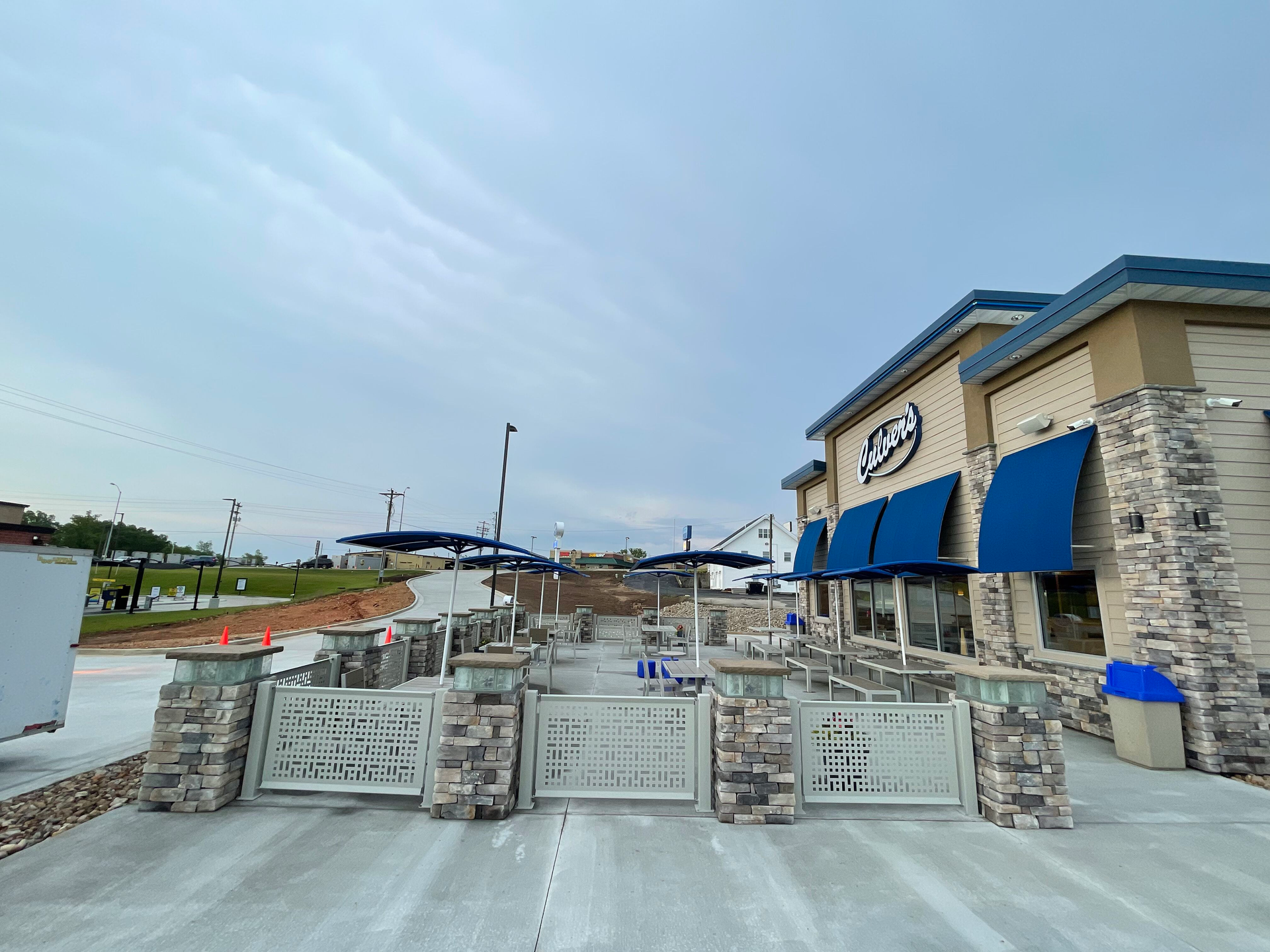 A large building with blue awnings on the side of it.