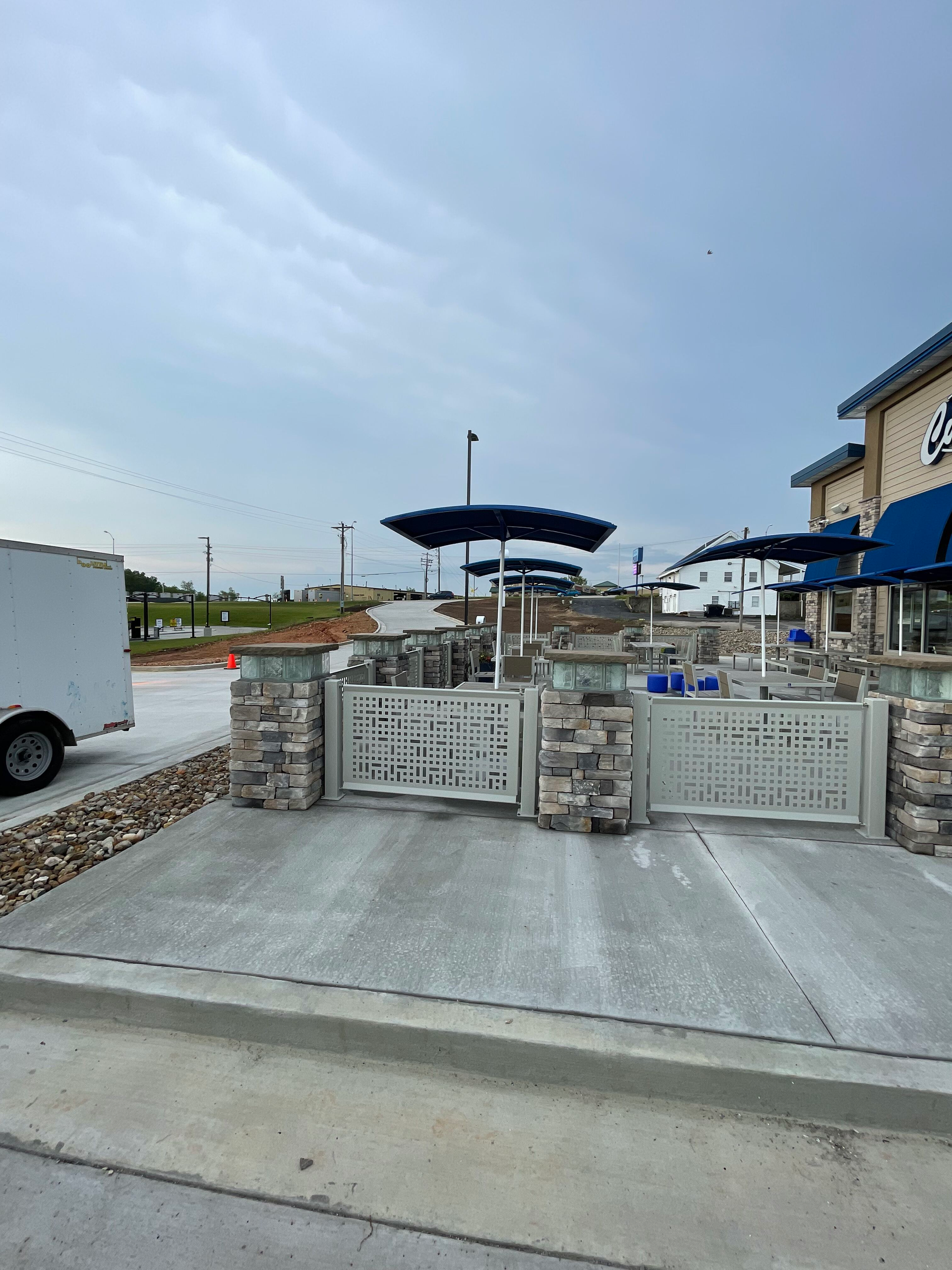 A white truck is parked in front of a building.