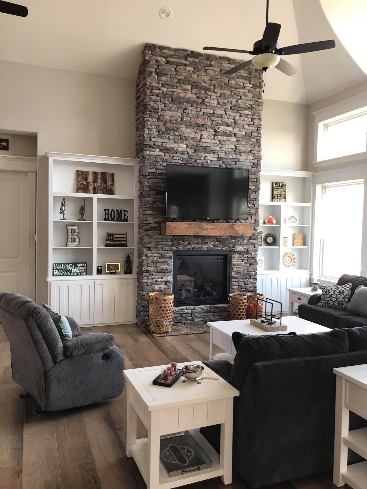 A living room with a fireplace and a flat screen tv.