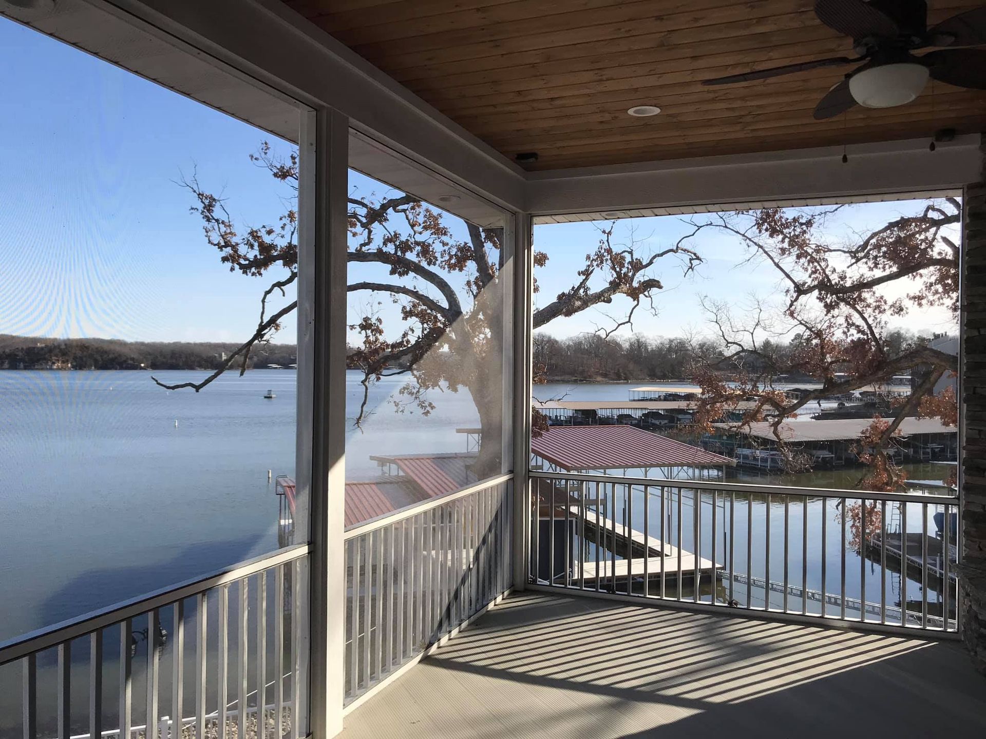 A screened in porch with a view of a lake