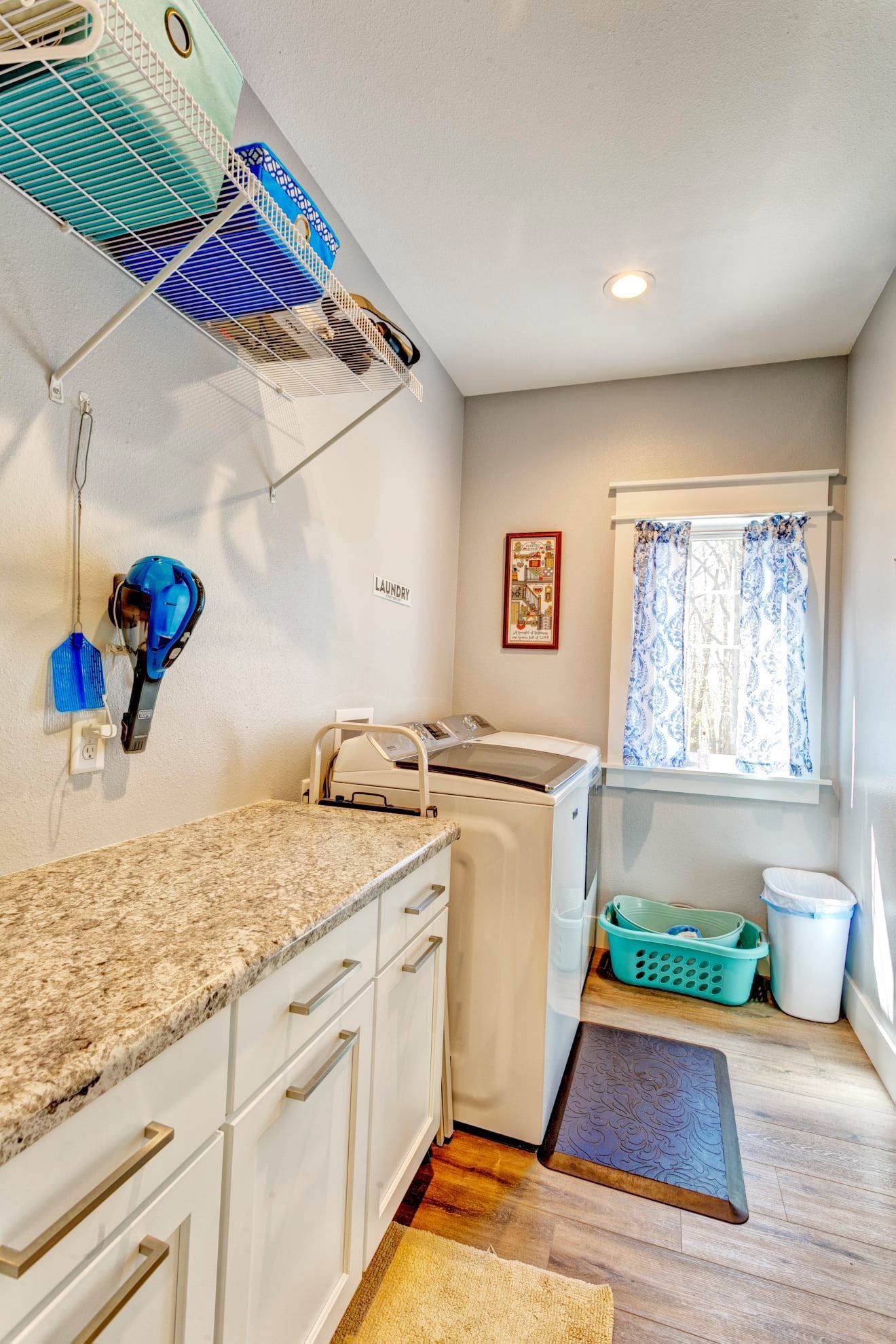A laundry room with a washer and dryer and a window.