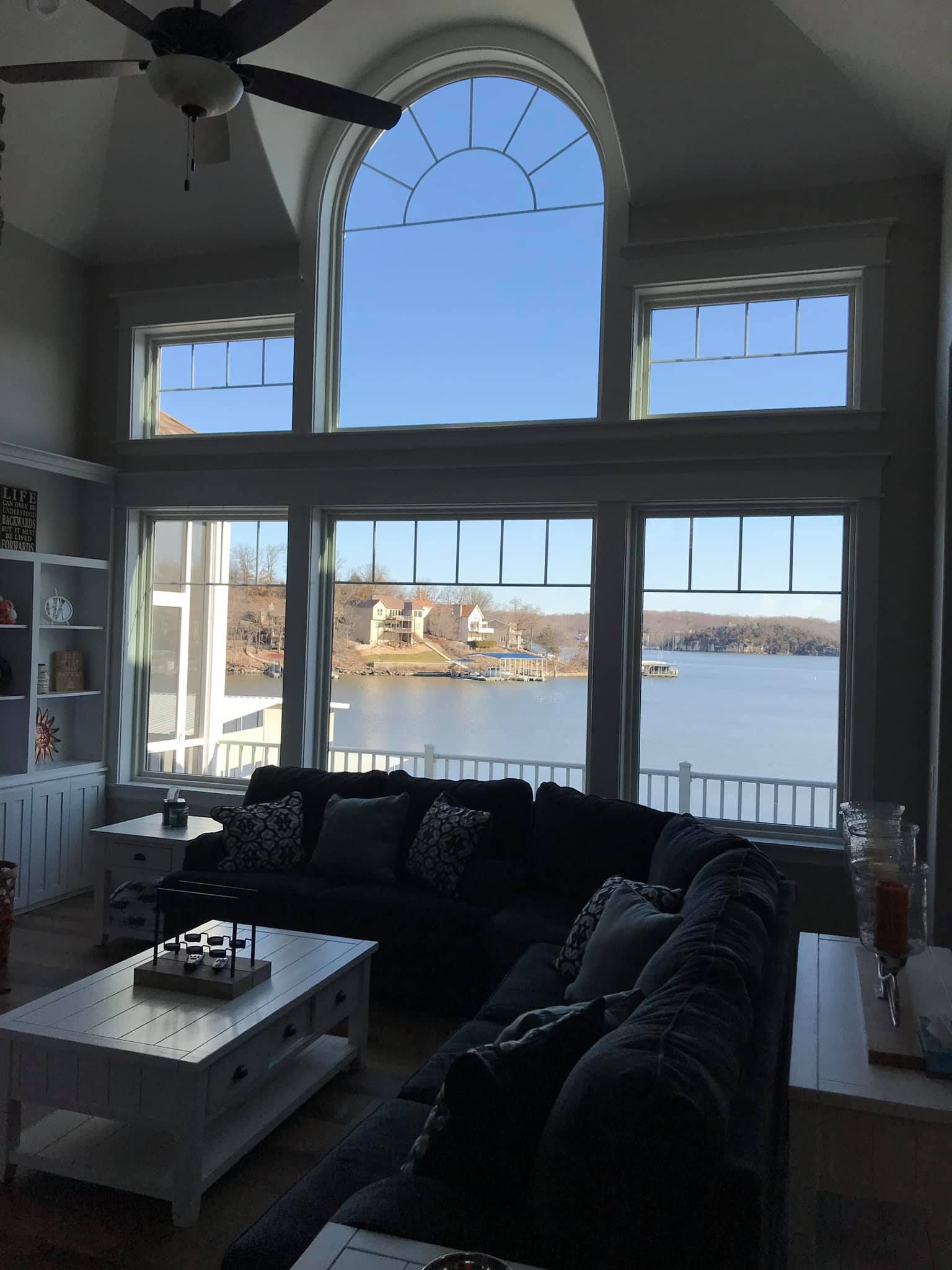 A living room with a large window overlooking a lake