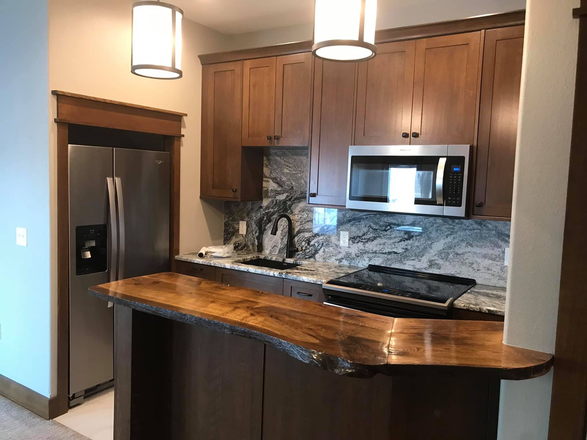 A kitchen with stainless steel appliances and wooden cabinets