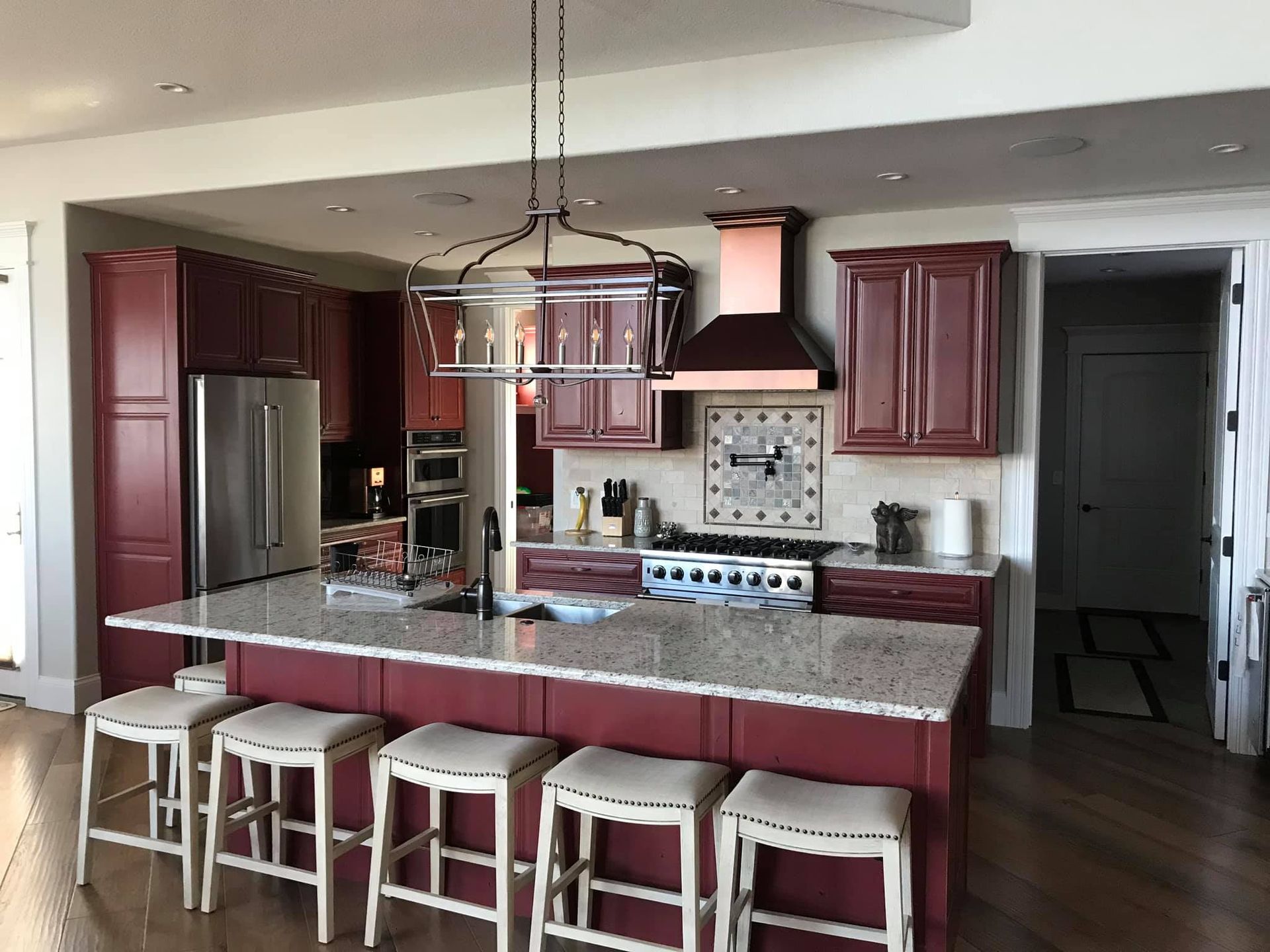 A kitchen with a large island and stools