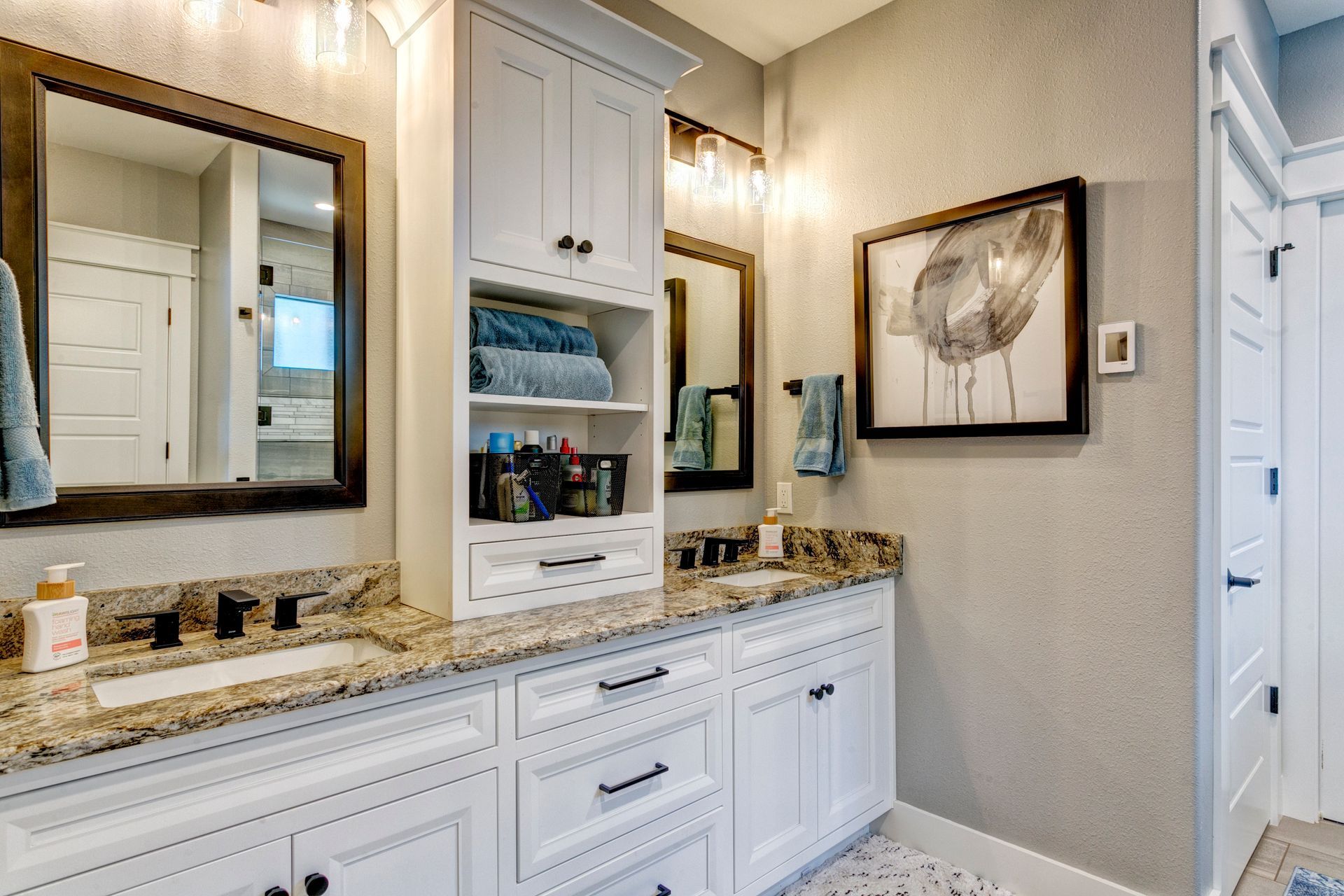 A bathroom with two sinks and two mirrors