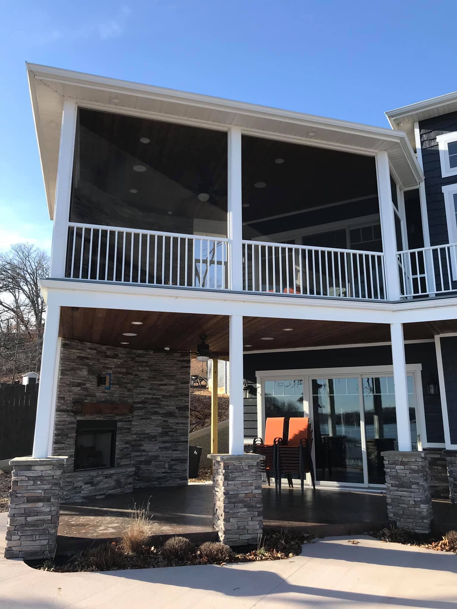A large house with a screened in porch and a fireplace