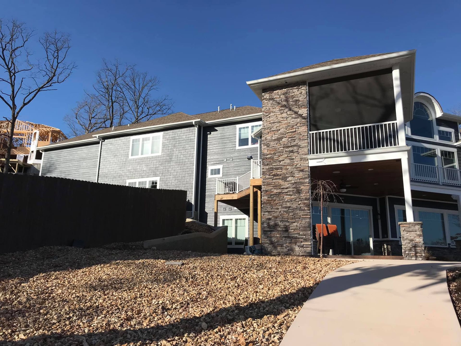 A large house with a lot of windows and a walkway leading to it.