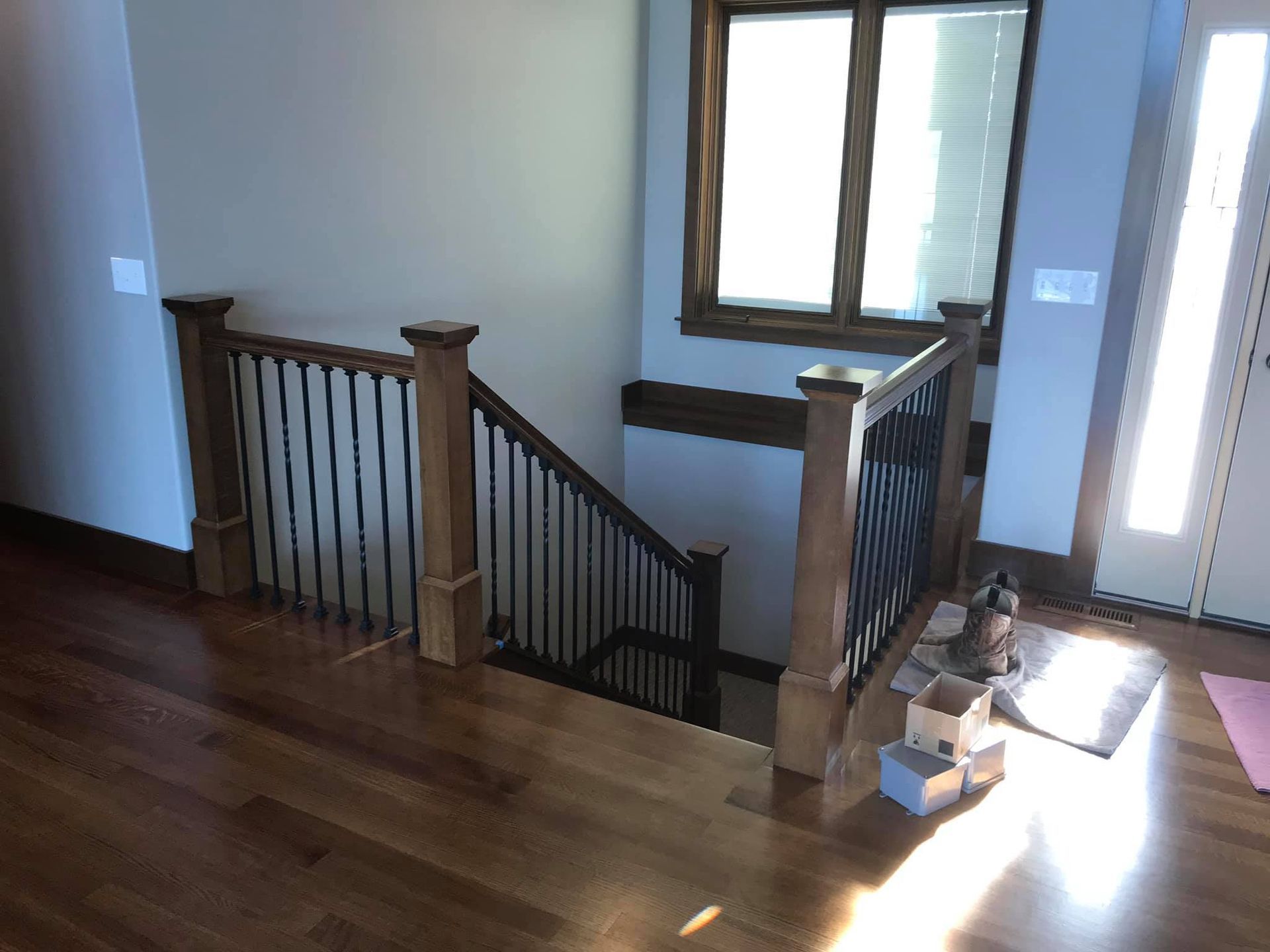A wooden staircase with a metal railing in a house.