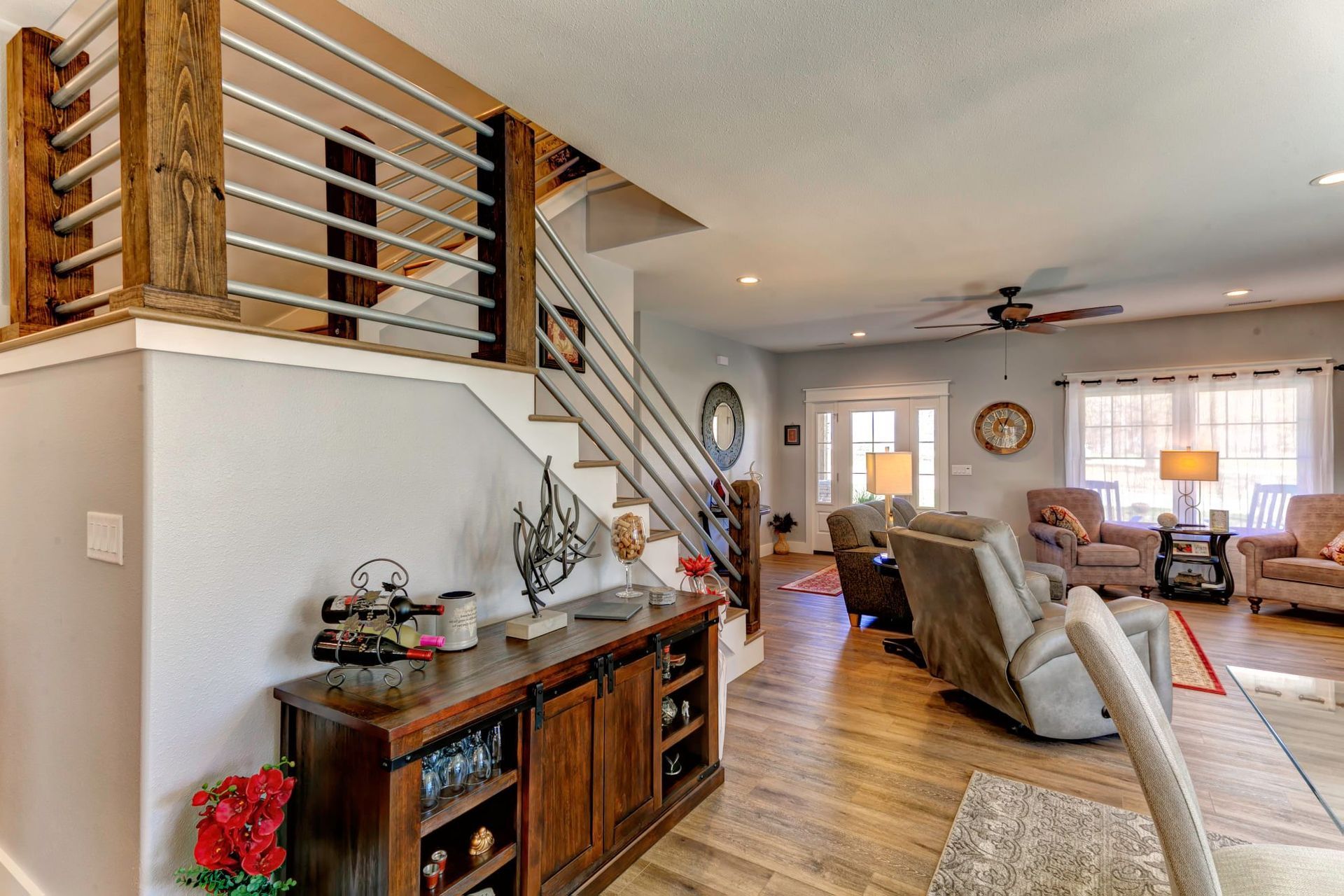 A living room with a staircase leading up to the second floor.