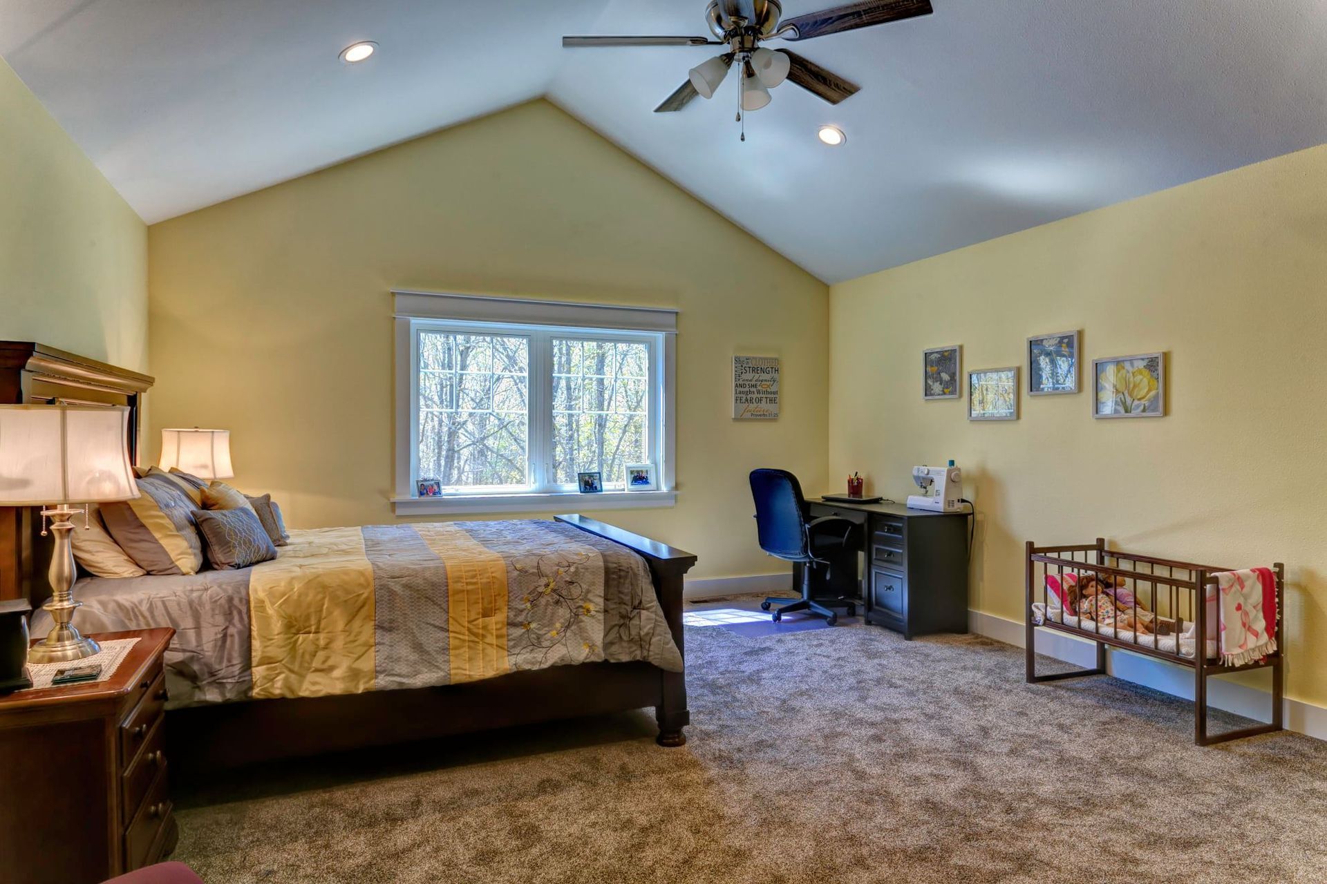A bedroom with a ceiling fan and a bed