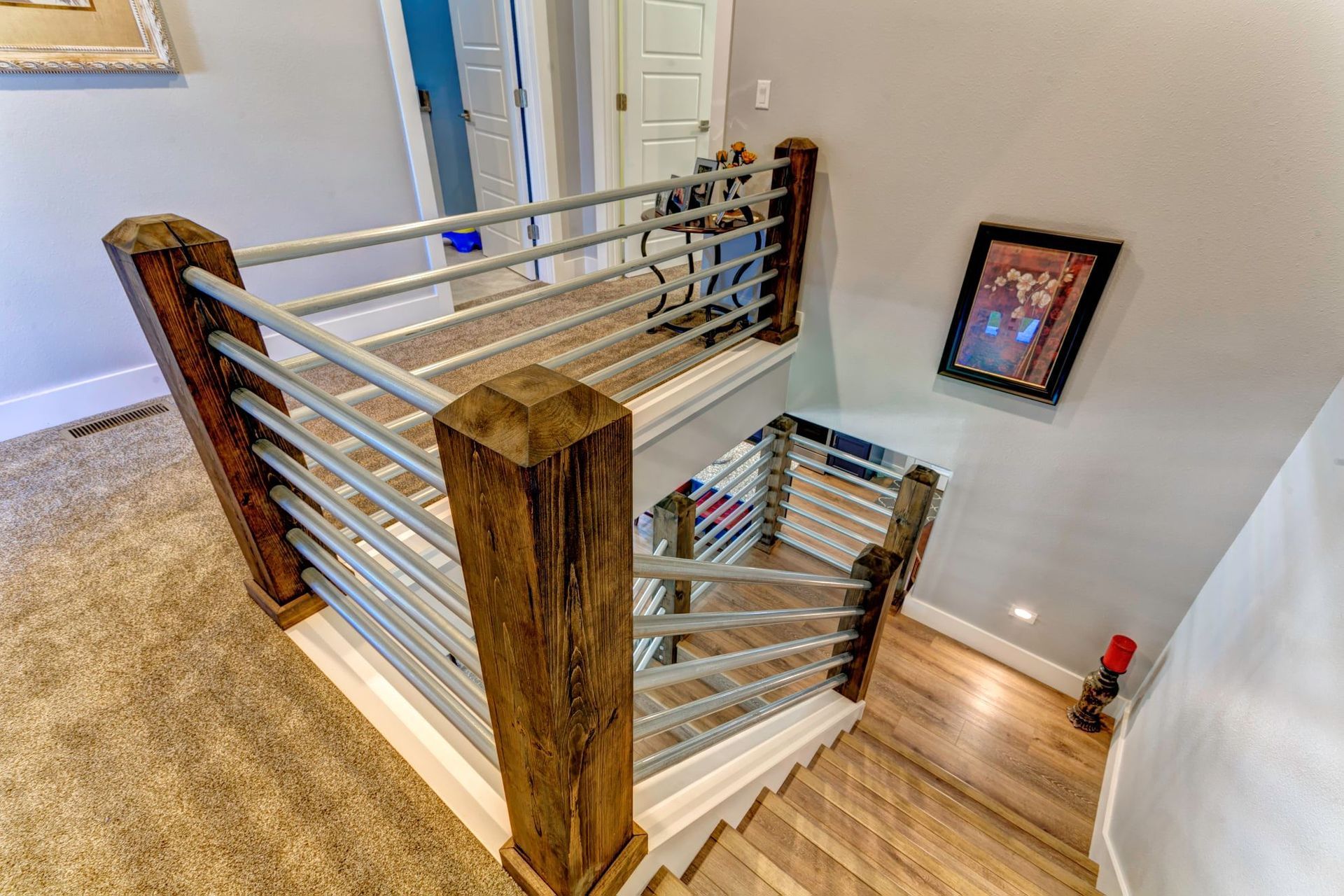 The stairs are made of wood and metal and have a metal railing.