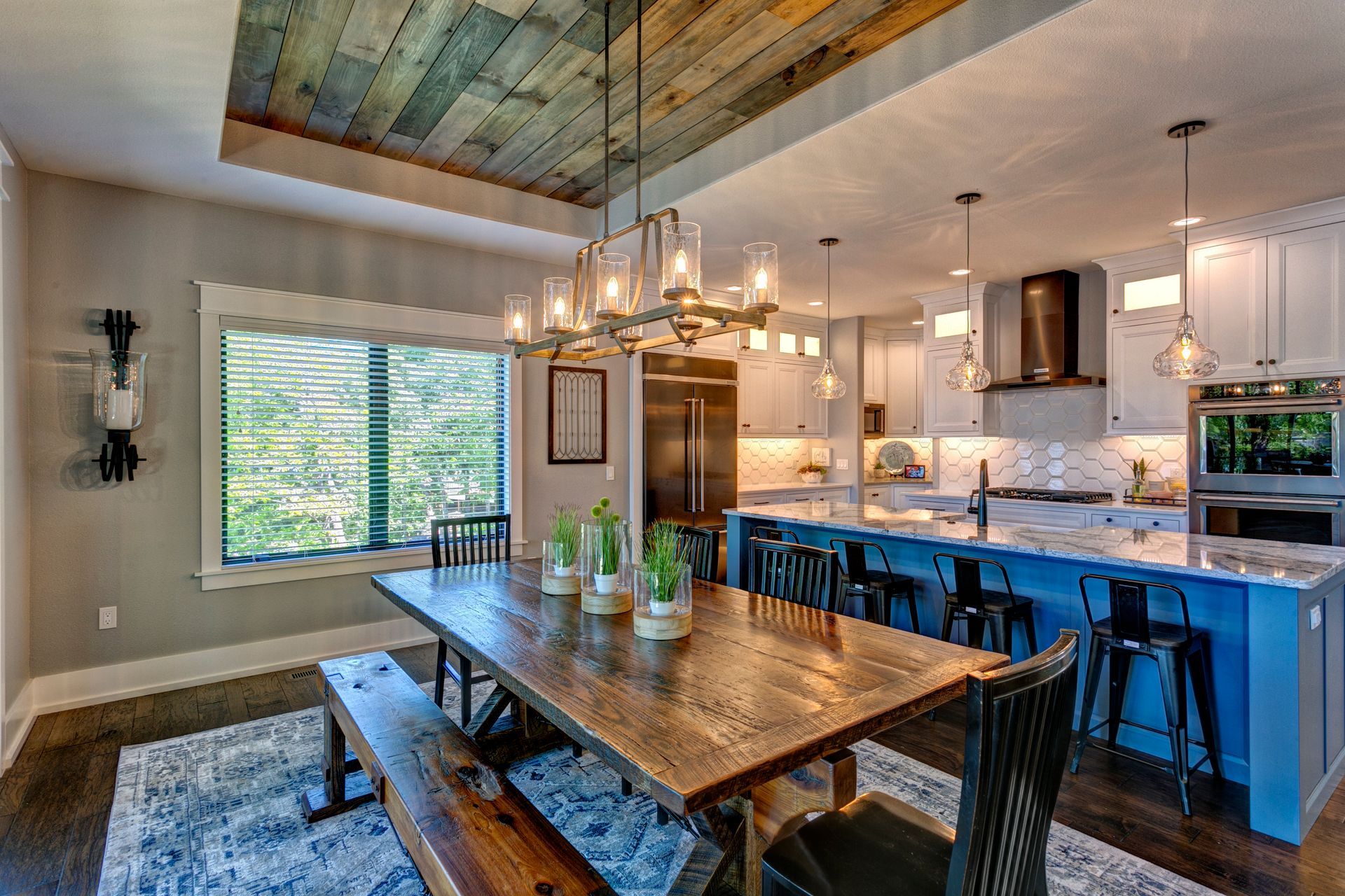 A dining room table with a bench and chairs in a kitchen.