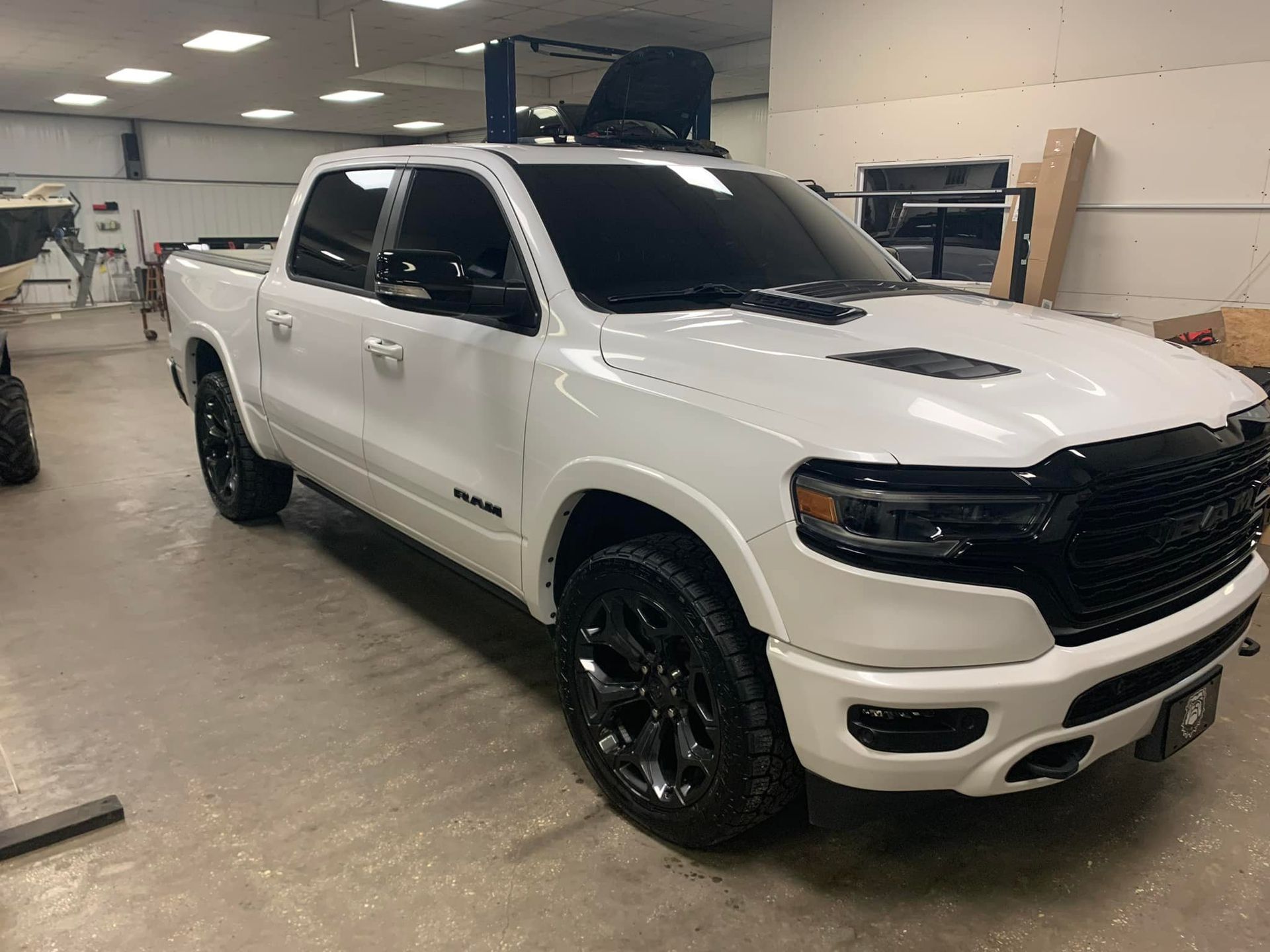 A white ram 1500 truck is parked in a garage.