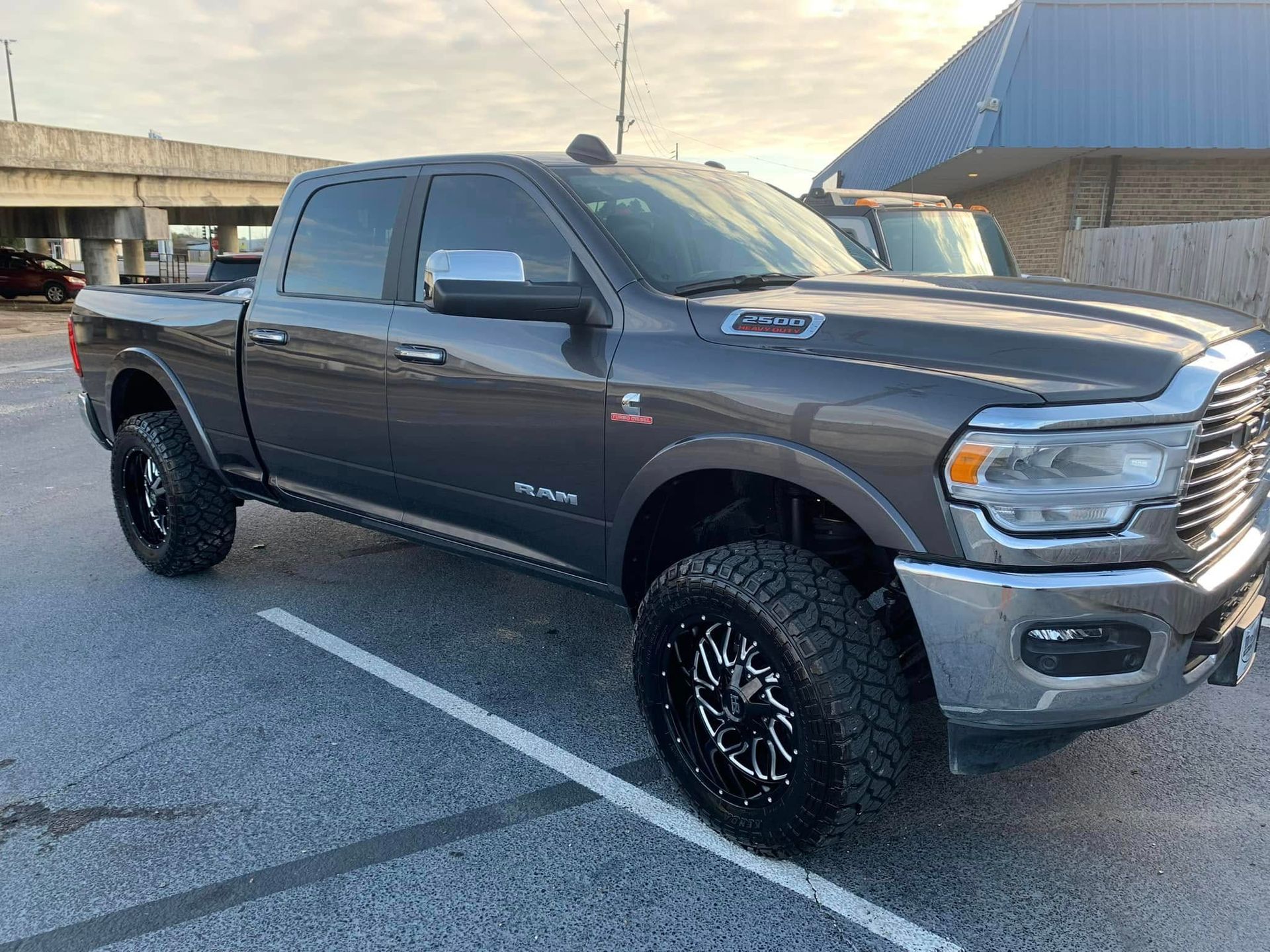 A gray ram truck is parked in a parking lot.