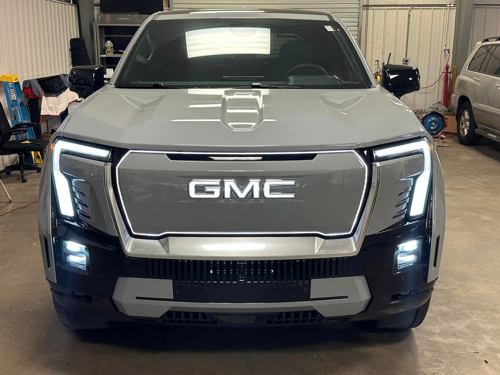 A gmc truck is parked in a garage.