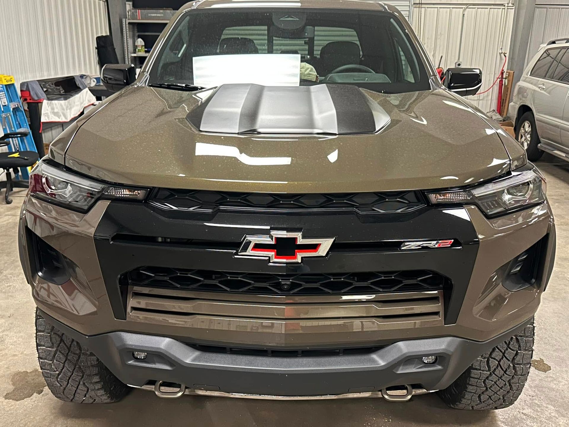 A brown chevrolet truck is parked in a garage.