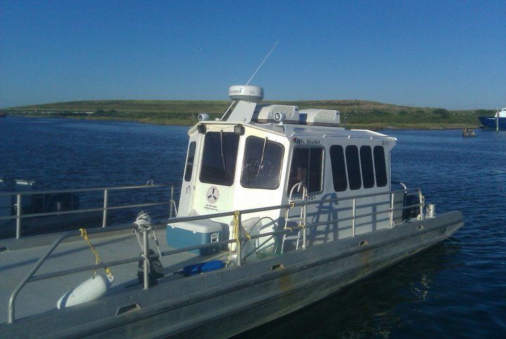 A small boat is docked at a dock in the water
