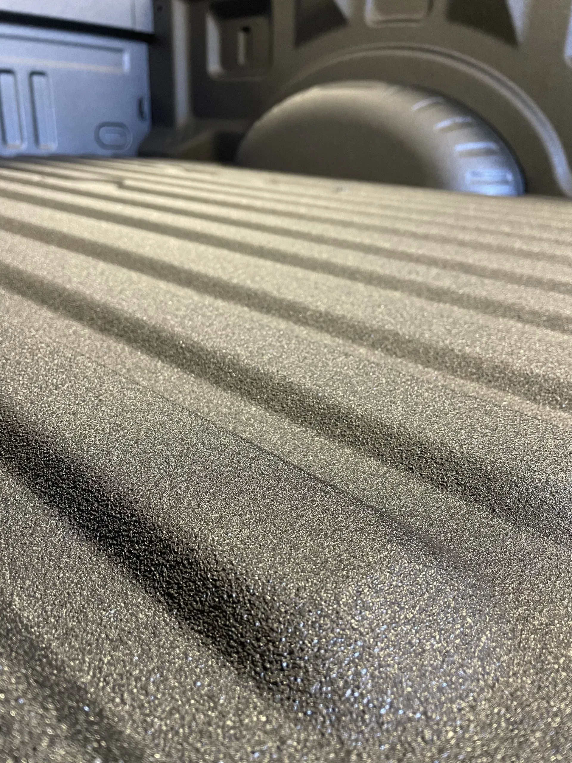 A close up of a truck bed with a lot of lines on it.