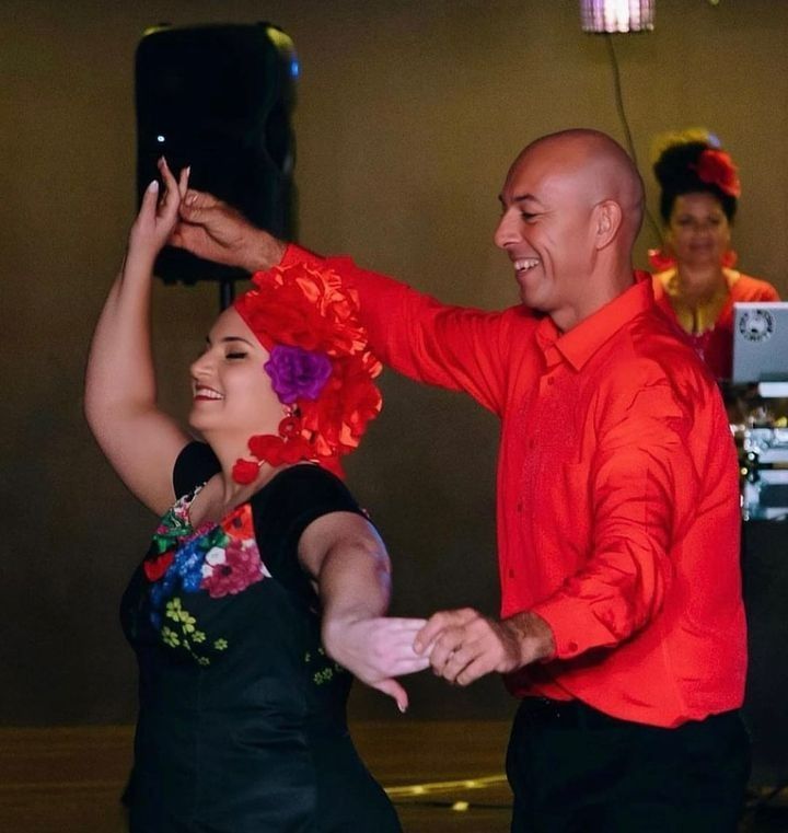 A Man In A Red Shirt Is Dancing With A Woman In A Black Dress — Global Dance Collective In West End, QLD