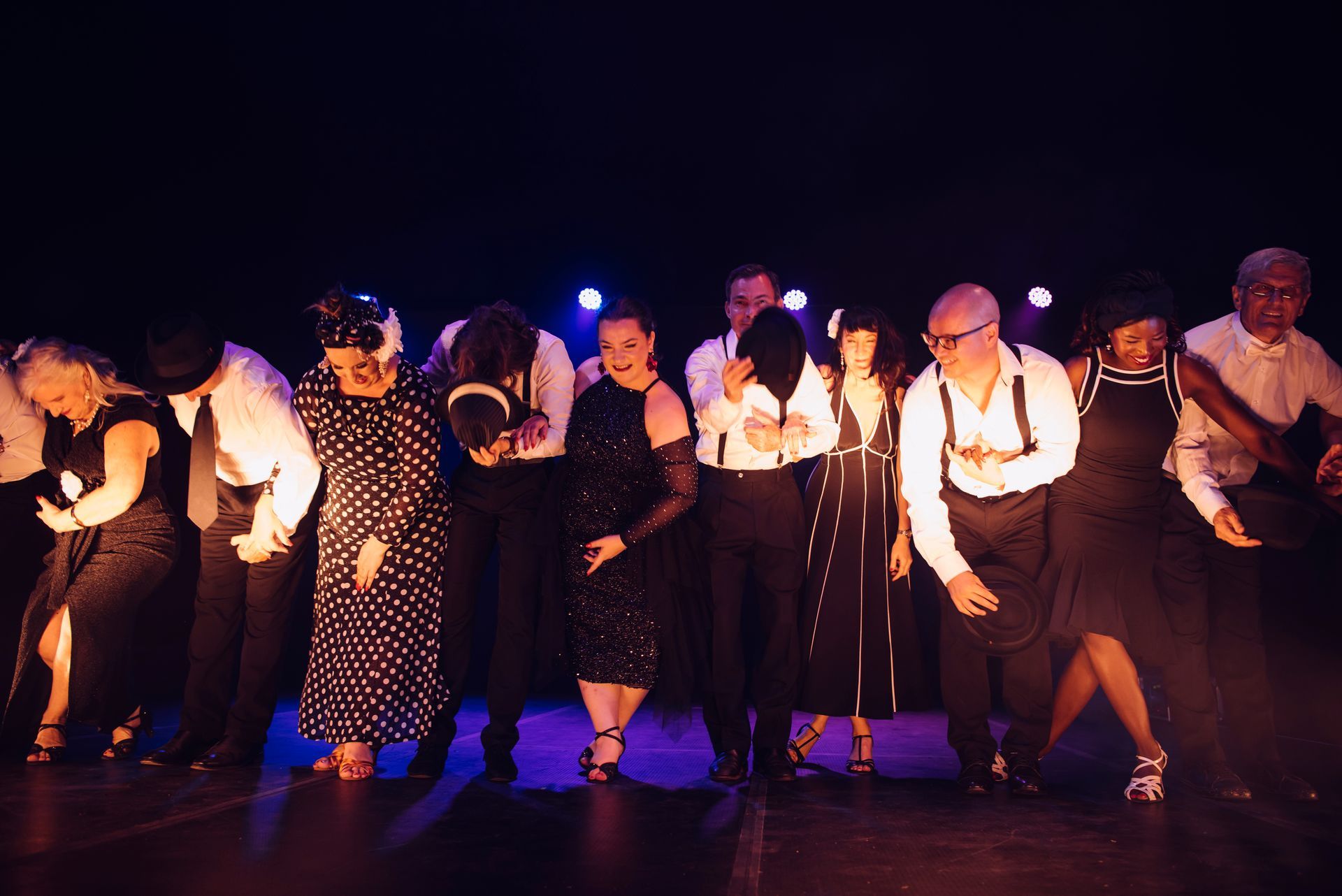A group of people are dancing on a stage in a dark room — Global Dance Collective In West End, QLD