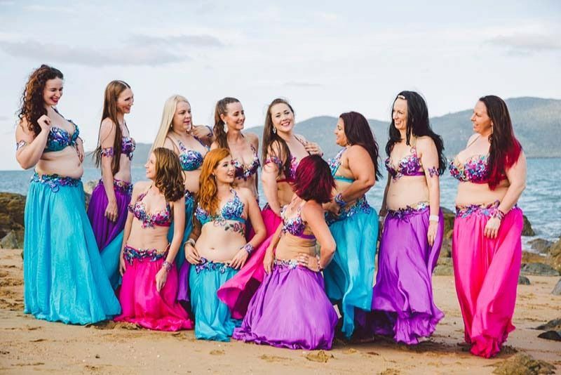 A Group Of Belly Dancers Are Posing For A Picture On The Beach — Global Dance Collective In West End, QLD