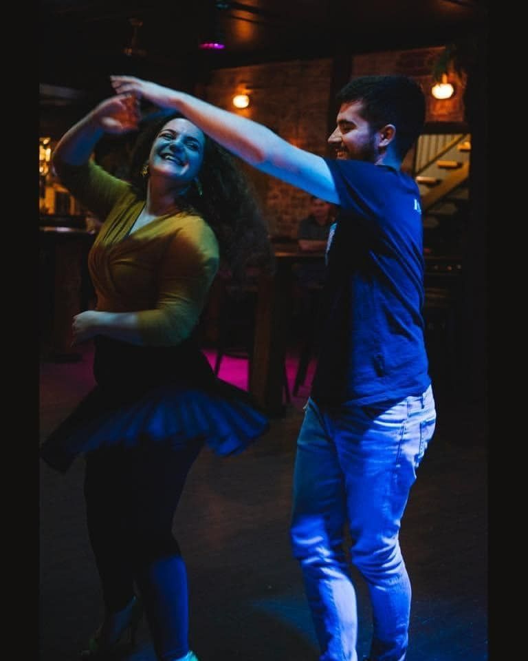 A Man And A Woman Are Dancing Together In A Dark Room — Global Dance Collective In West End, QLD
