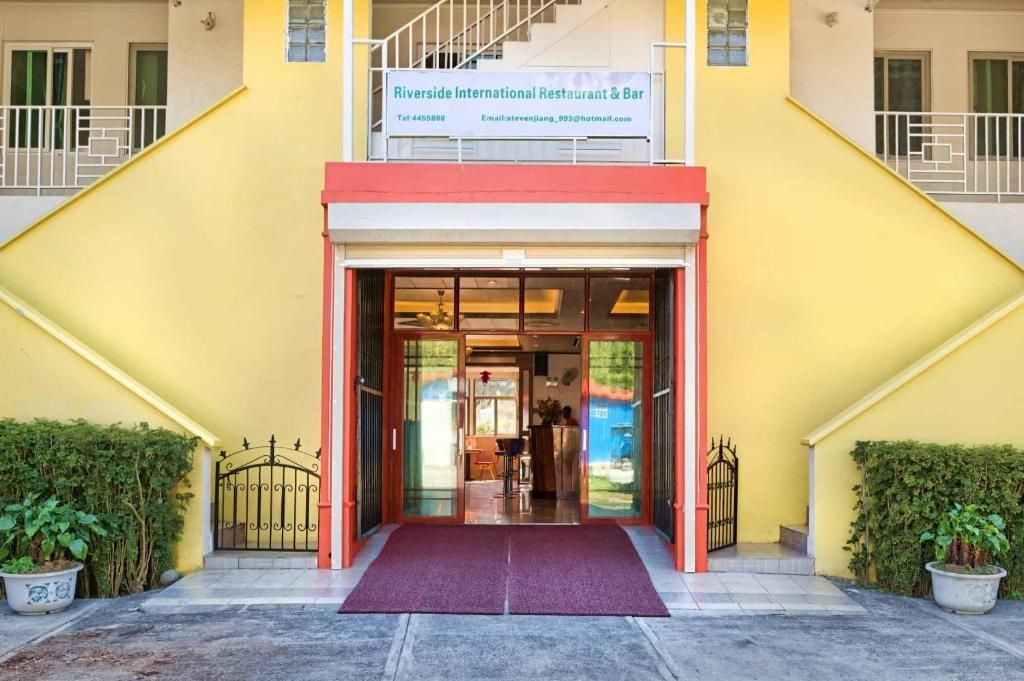 Entrance to Emerald International Golf Club in El Nido, Palawan. Yellow building with red trim.