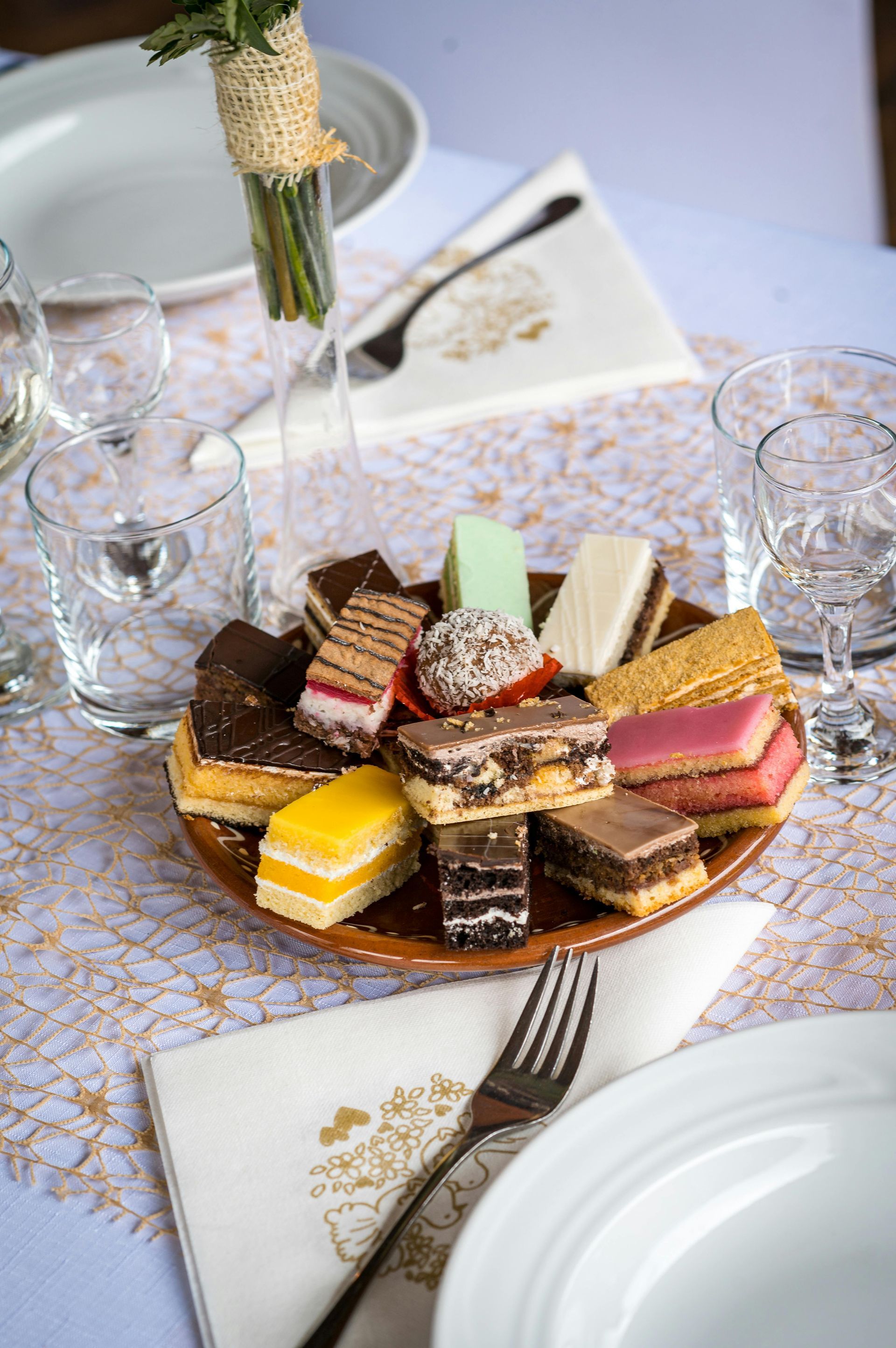 Shrimp and vegetables on a white plate with rice and silverware on a white tablecloth.